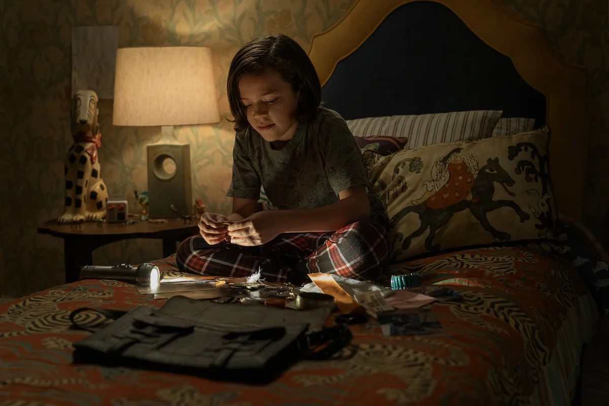 Acston Luca Porto as Jake Kennedy sits on his bed in The Whisper Man.