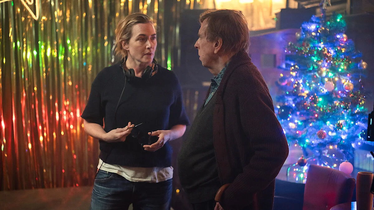 Kate Winslet speaks with Timothy Spall in an official Goodbye June production still from Netflix.
