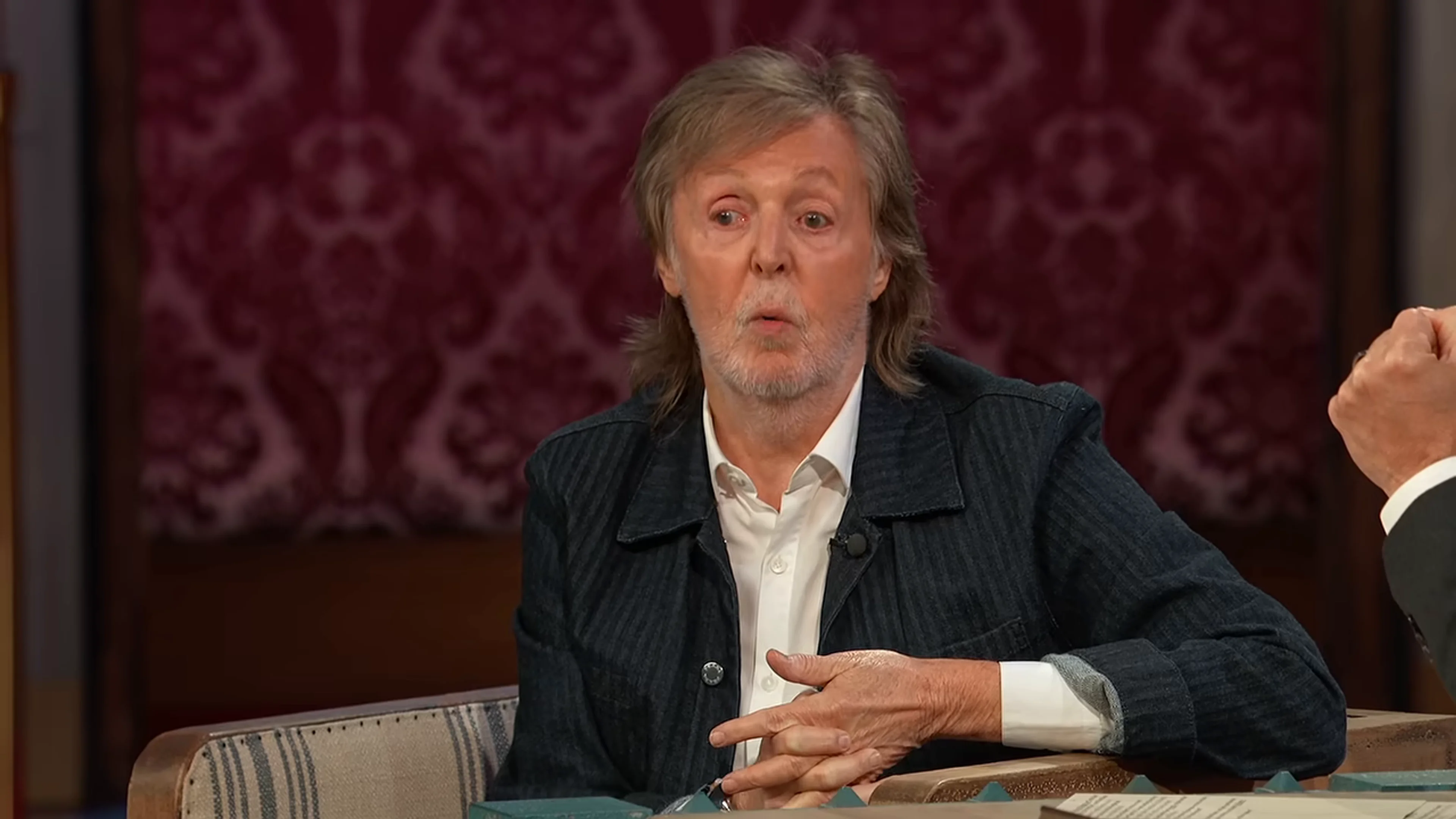 Paul McCartney gestures toward Jimmy Kimmel as they discuss working with Ringo Starr.