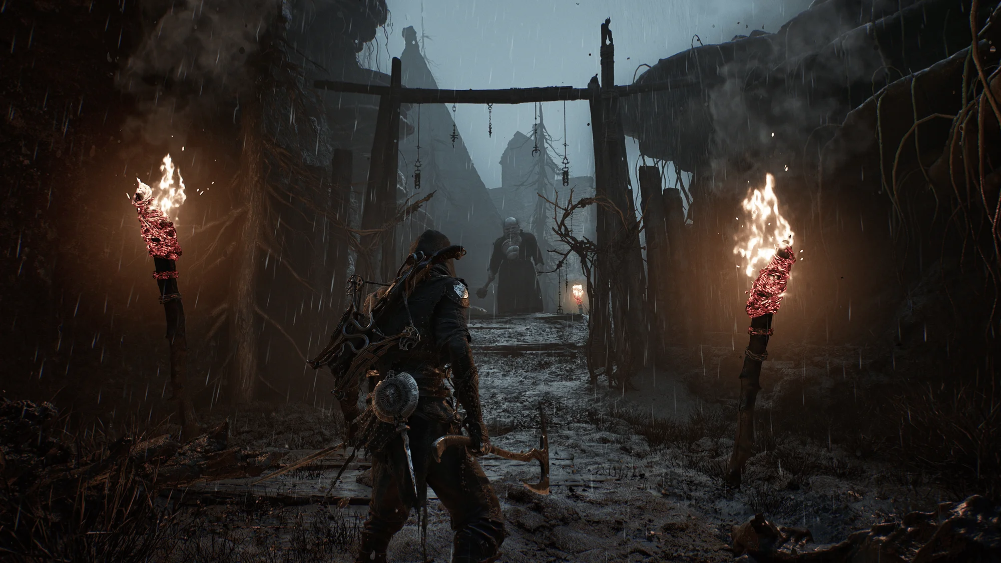 A Mortal Shell II warrior approaches a torch-lit enemy in a rain-soaked passage.