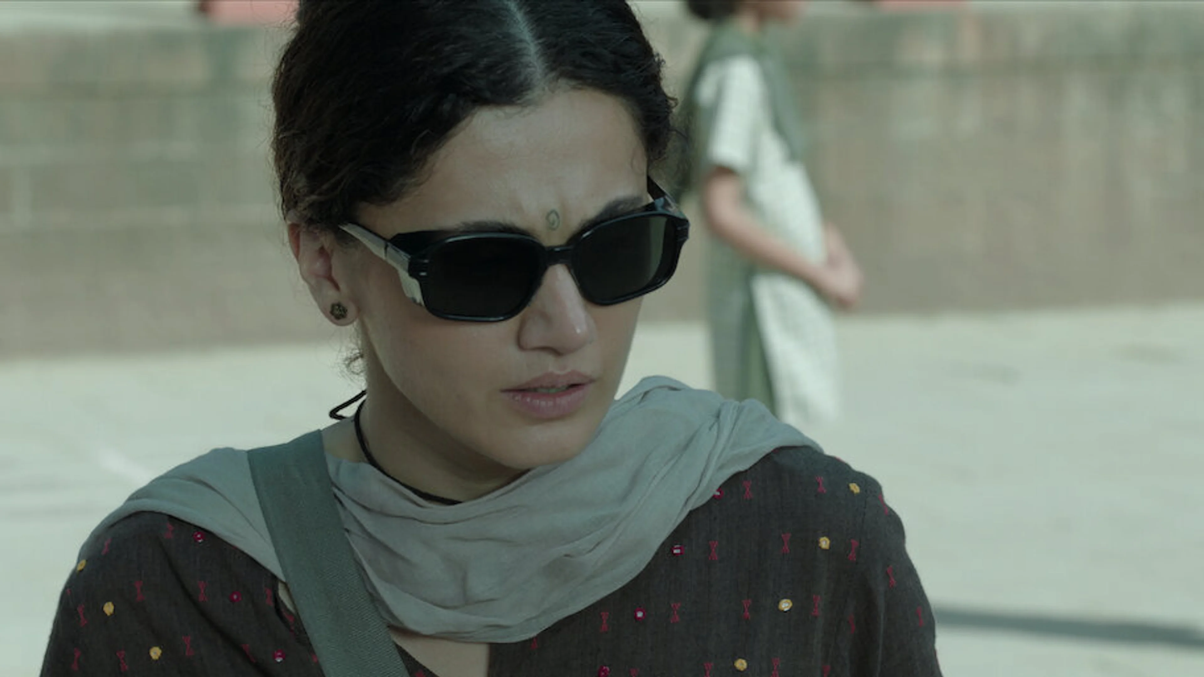 Taapsee Pannu wears dark sunglasses as Bani in an official Gandhari still from Netflix.