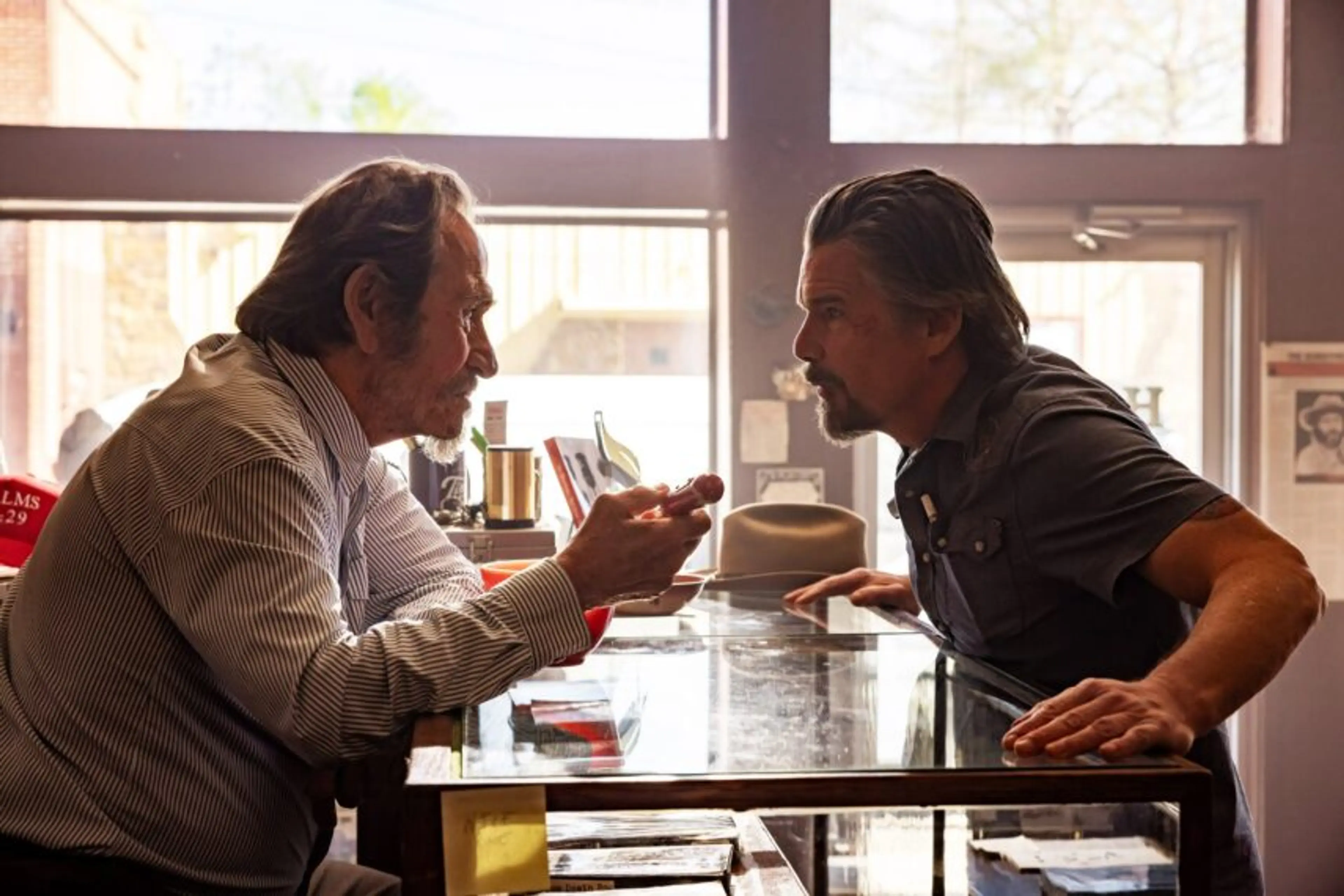 Tommy Lee Jones and Ethan Hawke face each other across Lee’s bookshop counter.