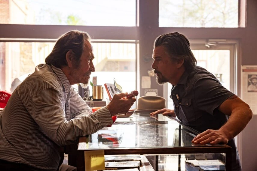 Tommy Lee Jones and Ethan Hawke face each other across Lee’s bookshop counter.