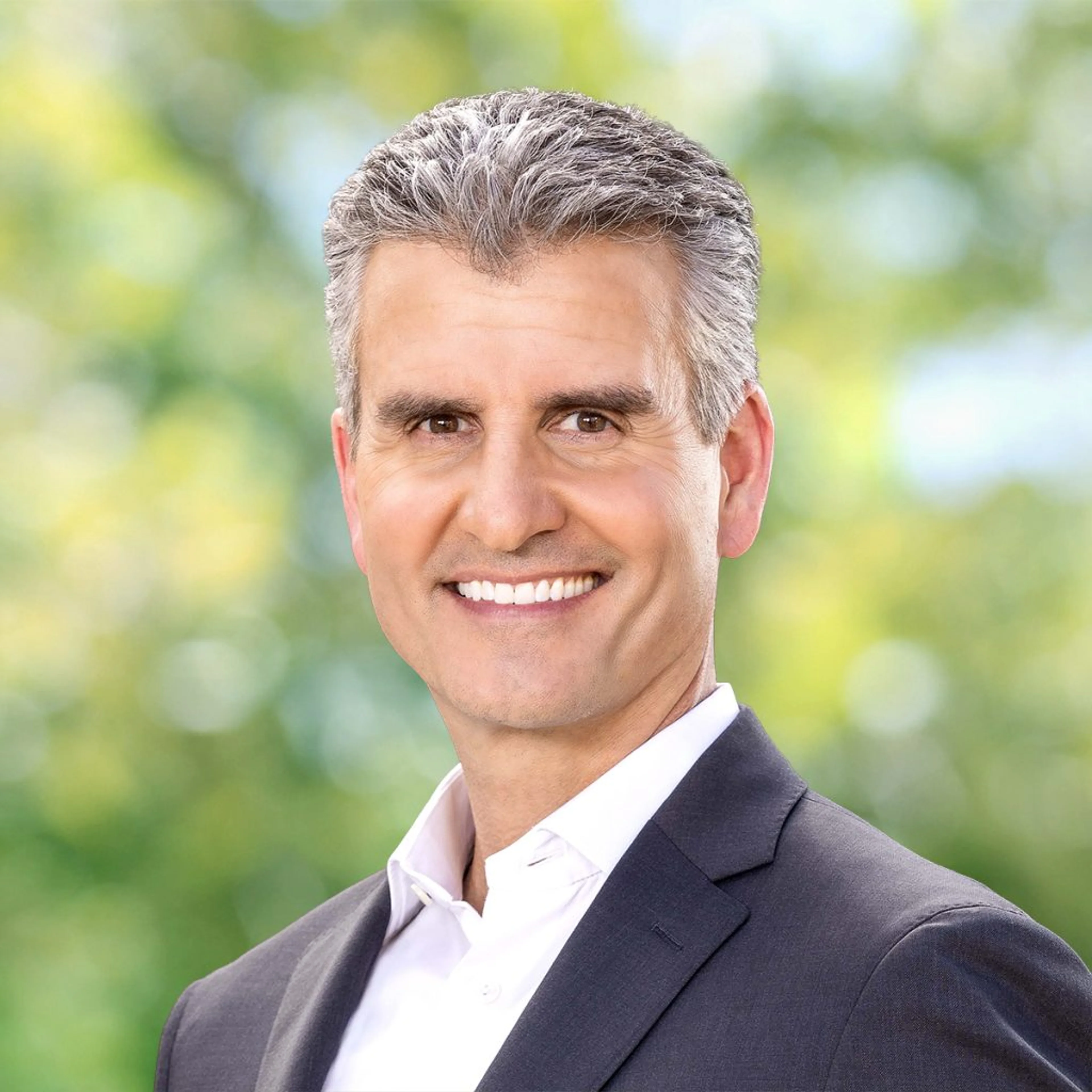 Josh D’Amaro smiles in an official Walt Disney Company portrait.