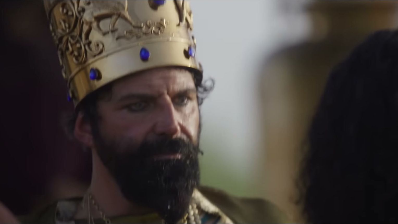 Elijah Alexander appears in a sharp close-up as King Nebuchadnezzar.