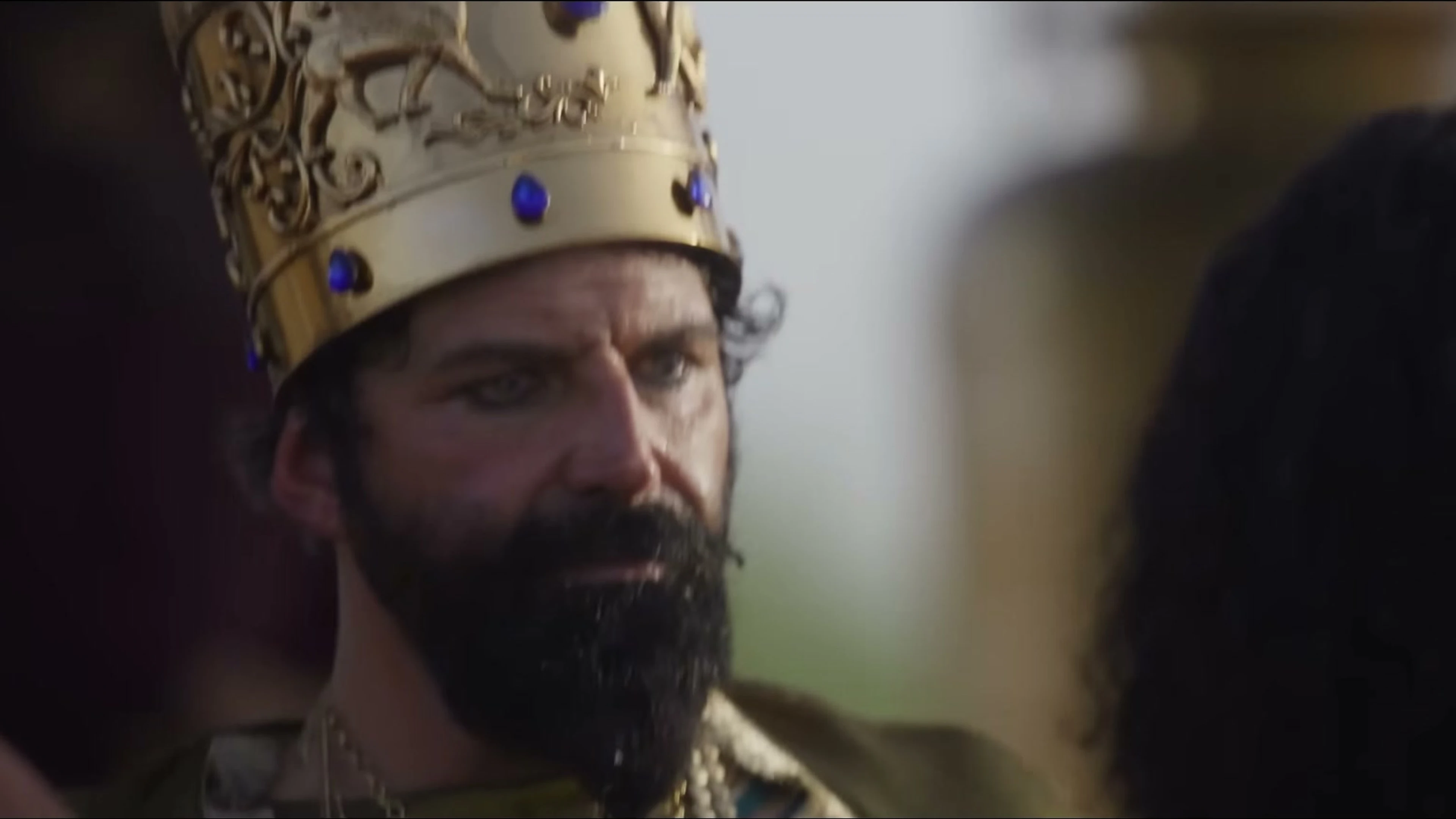 Elijah Alexander appears in a sharp close-up as King Nebuchadnezzar.