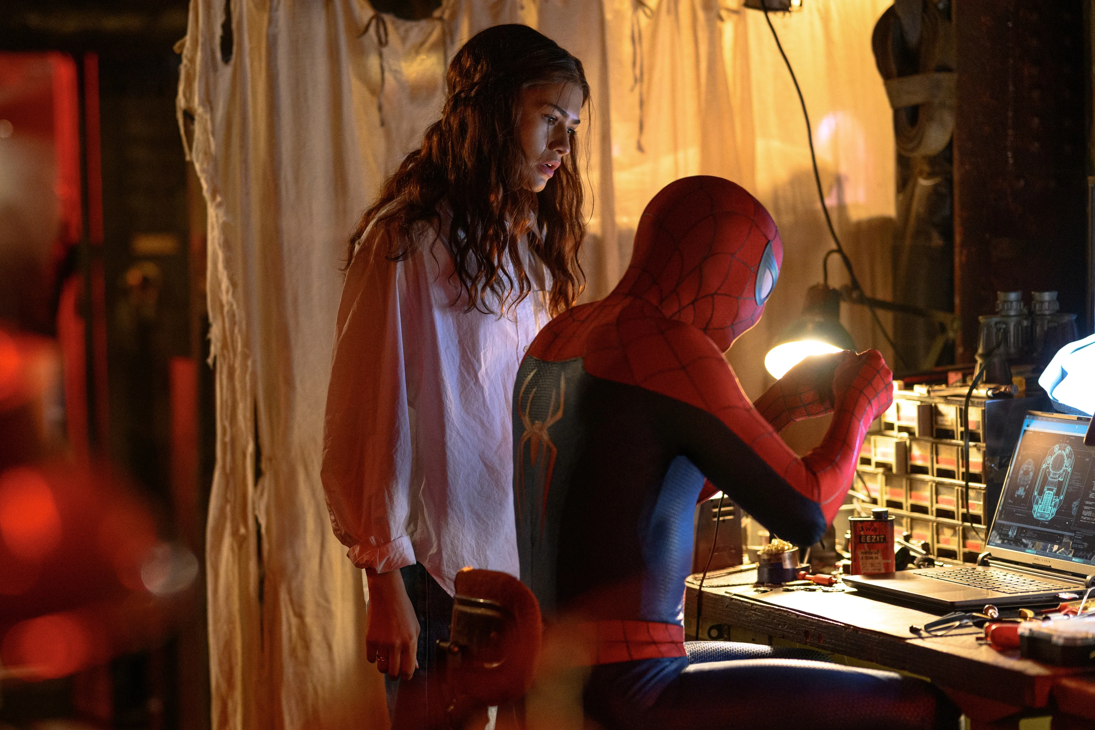 Zendaya stands beside Spider-Man while he works at a computer in Spider-Man: Brand New Day.