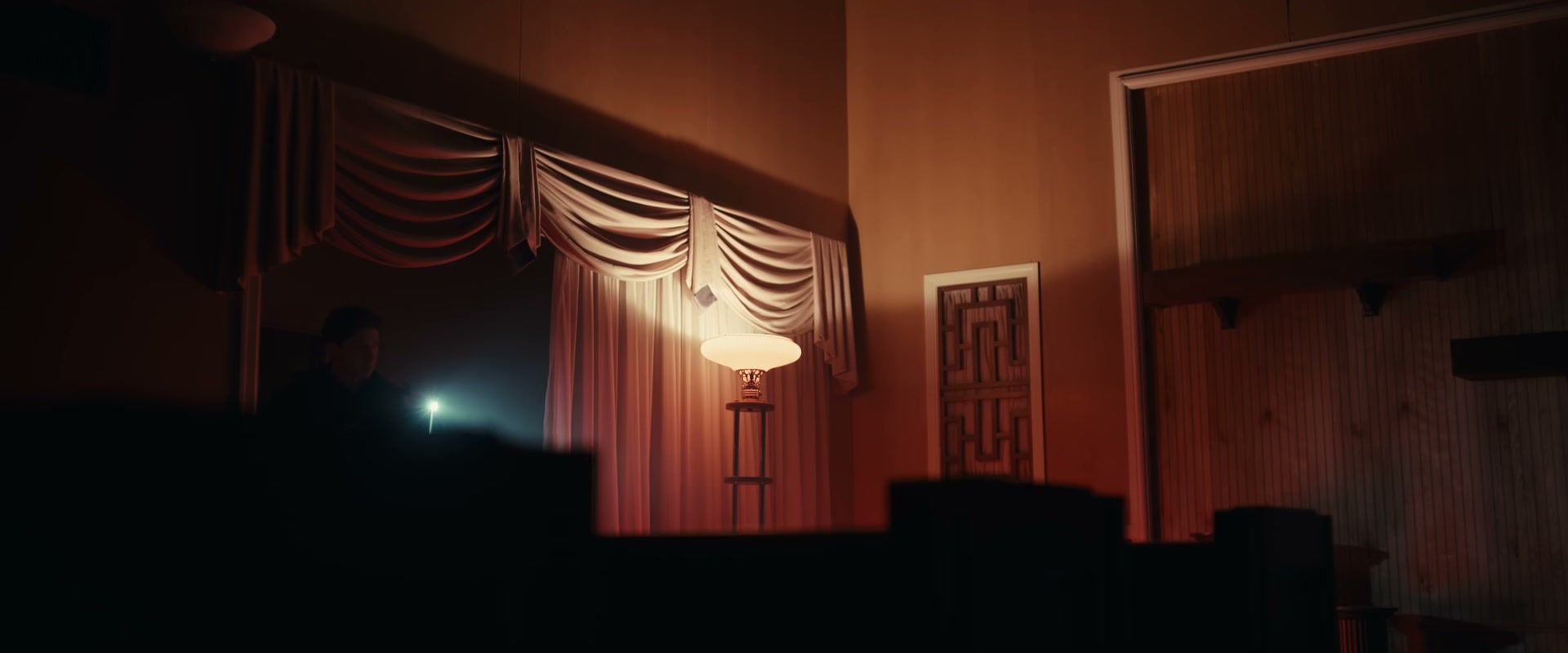 A dimly lit room appears in an official frame from The Cycle.