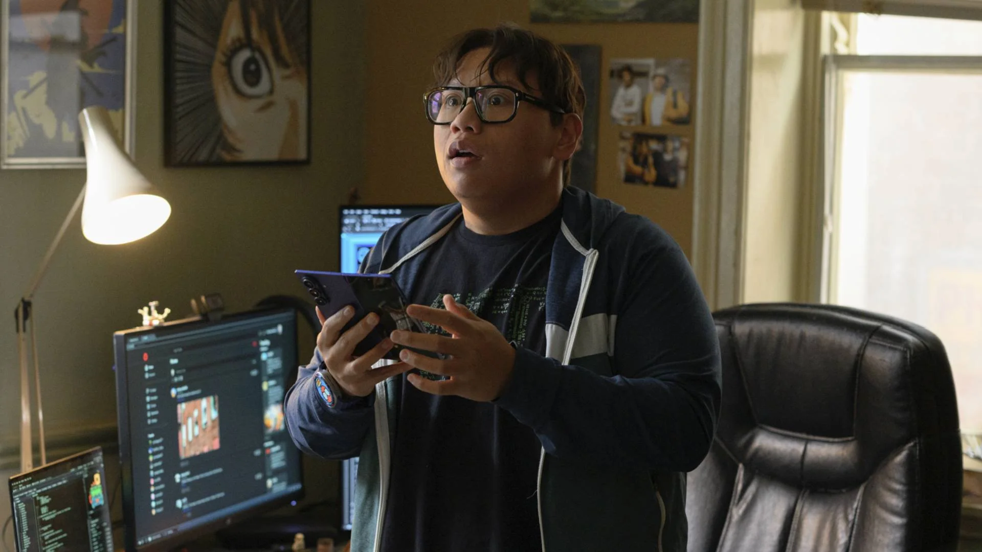Jacob Batalon as Ned Leeds holds a smartphone in Spider-Man: Brand New Day.