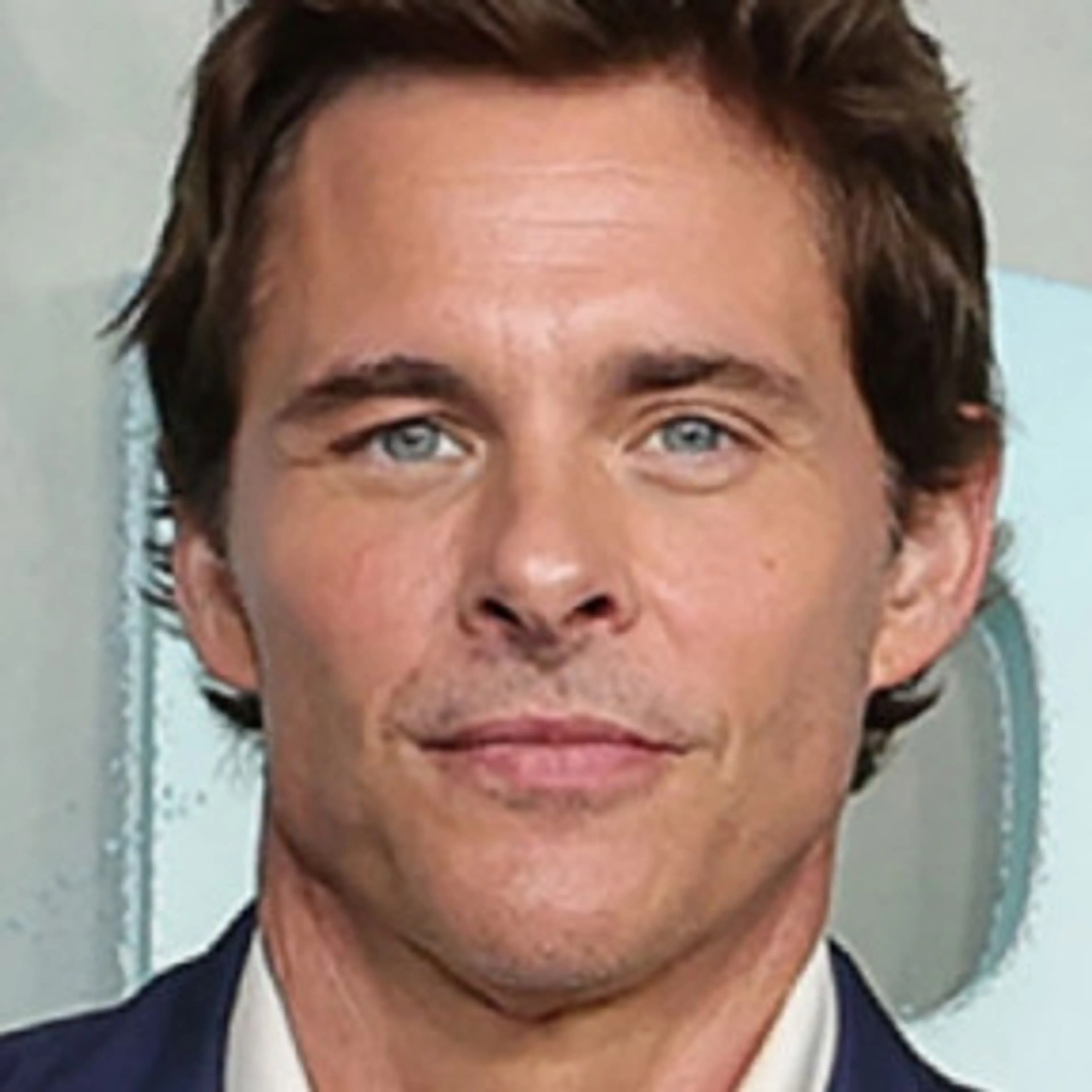 Portrait of James Marsden in a blue jacket and white shirt.