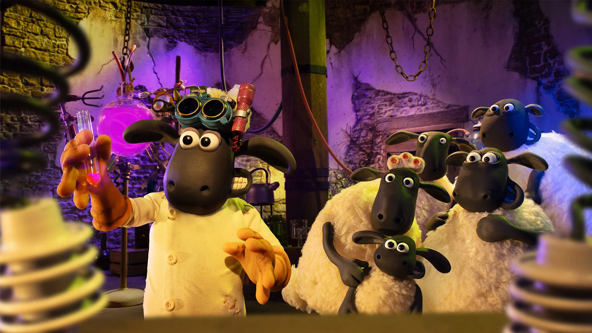 Shaun in goggles holds a test tube while the rest of the flock watches.