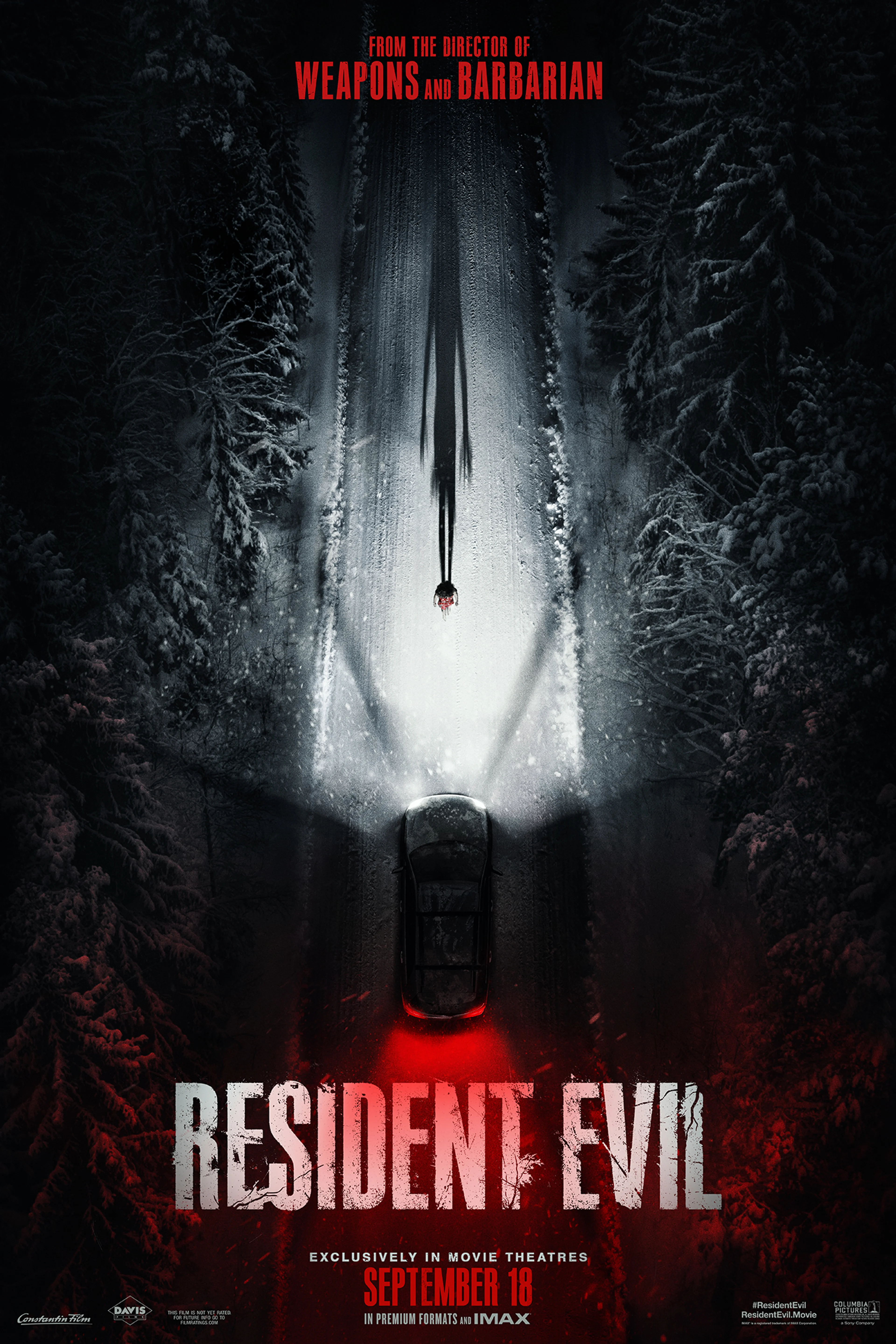 A car travels down a snowy road on the official Resident Evil key art from Sony Pictures.