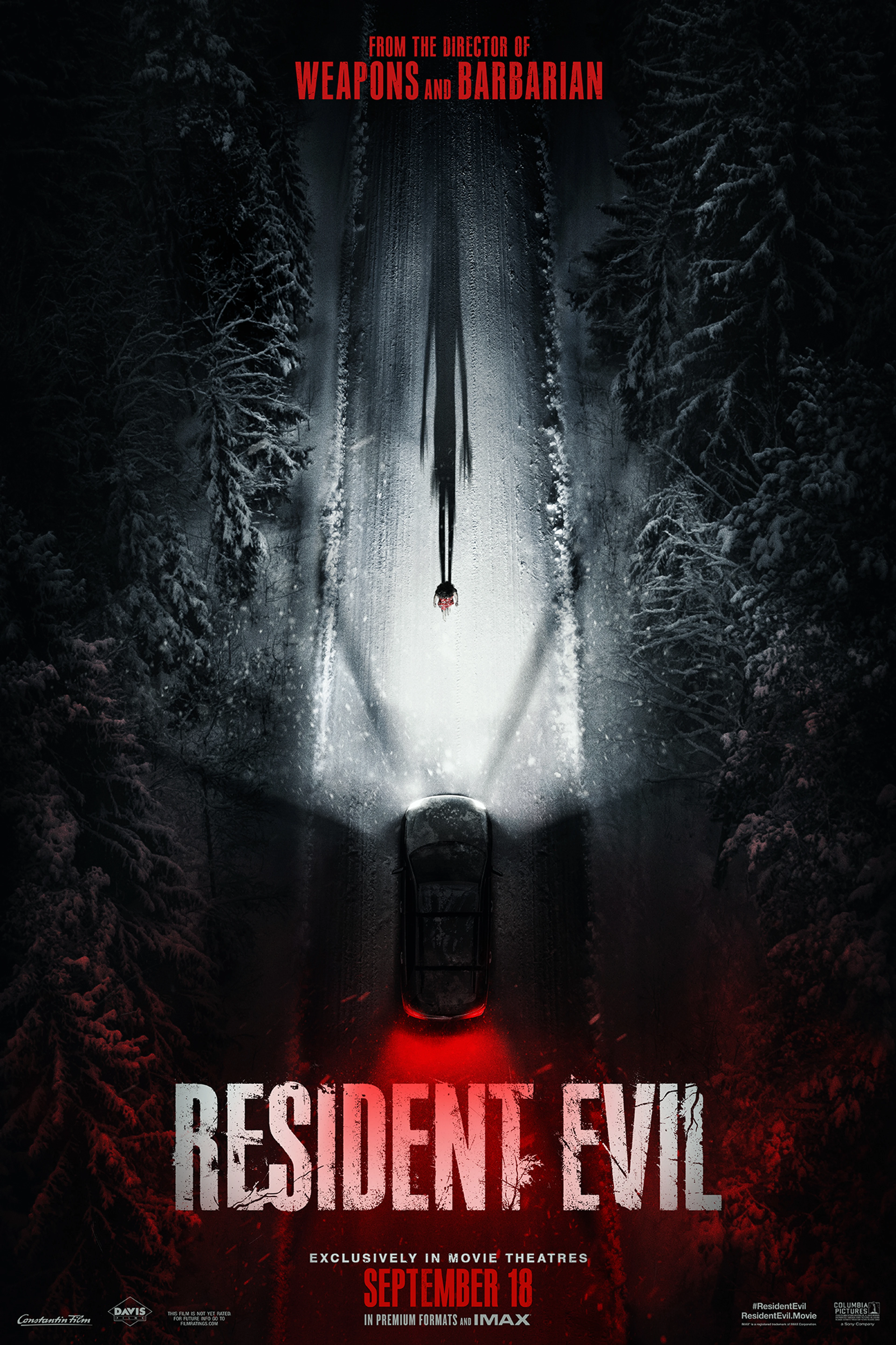A car travels down a snowy road on the official Resident Evil poster.
