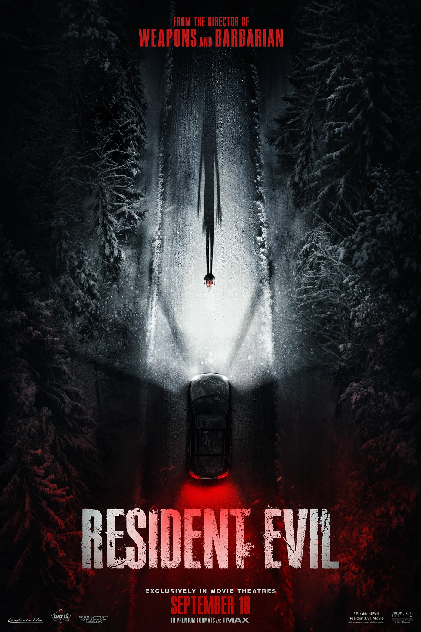 A car travels down a snowy road on the official Resident Evil key art from Sony Pictures.