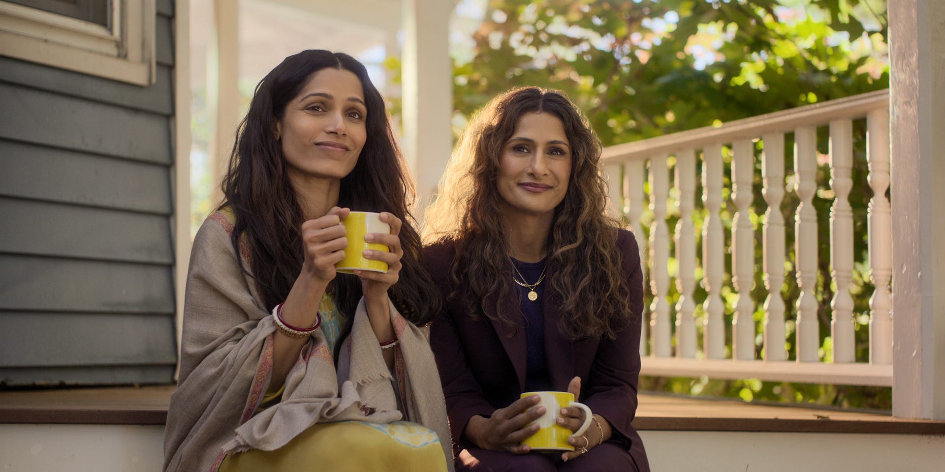 Freida Pinto and Sarayu Blue sit together in sunlight on a porch in Unaccustomed Earth.
