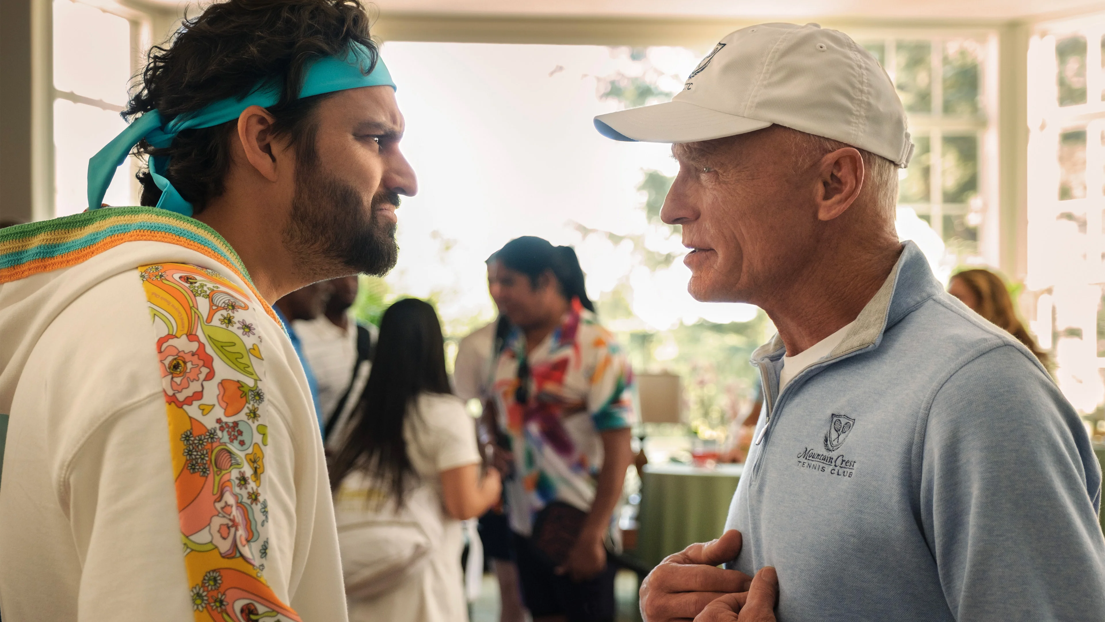 Jake Johnson as Dusty faces Ed Harris as Chuck at the country club.