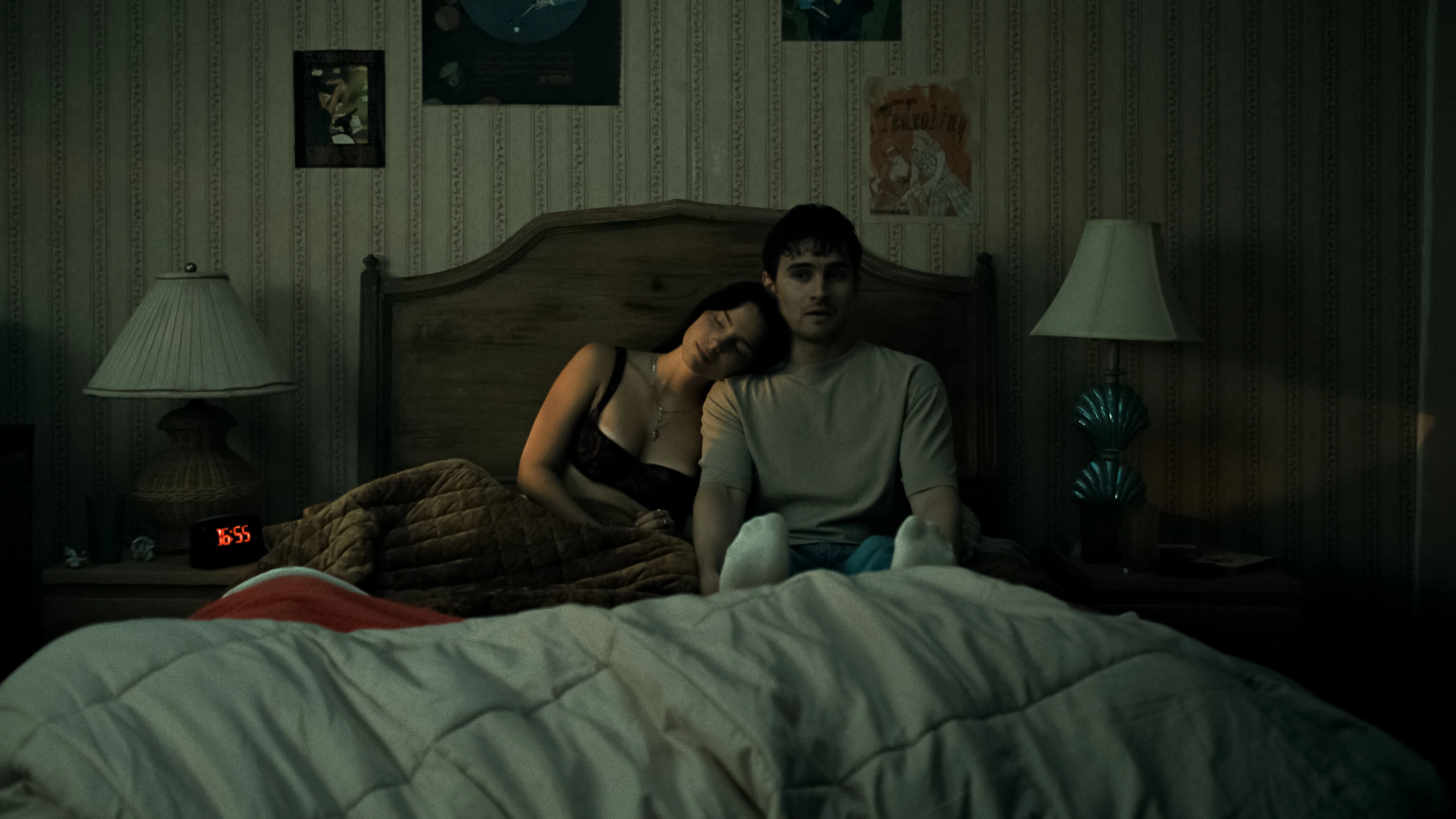 Nikki rests her head on Bear's shoulder while he sits awake in bed.