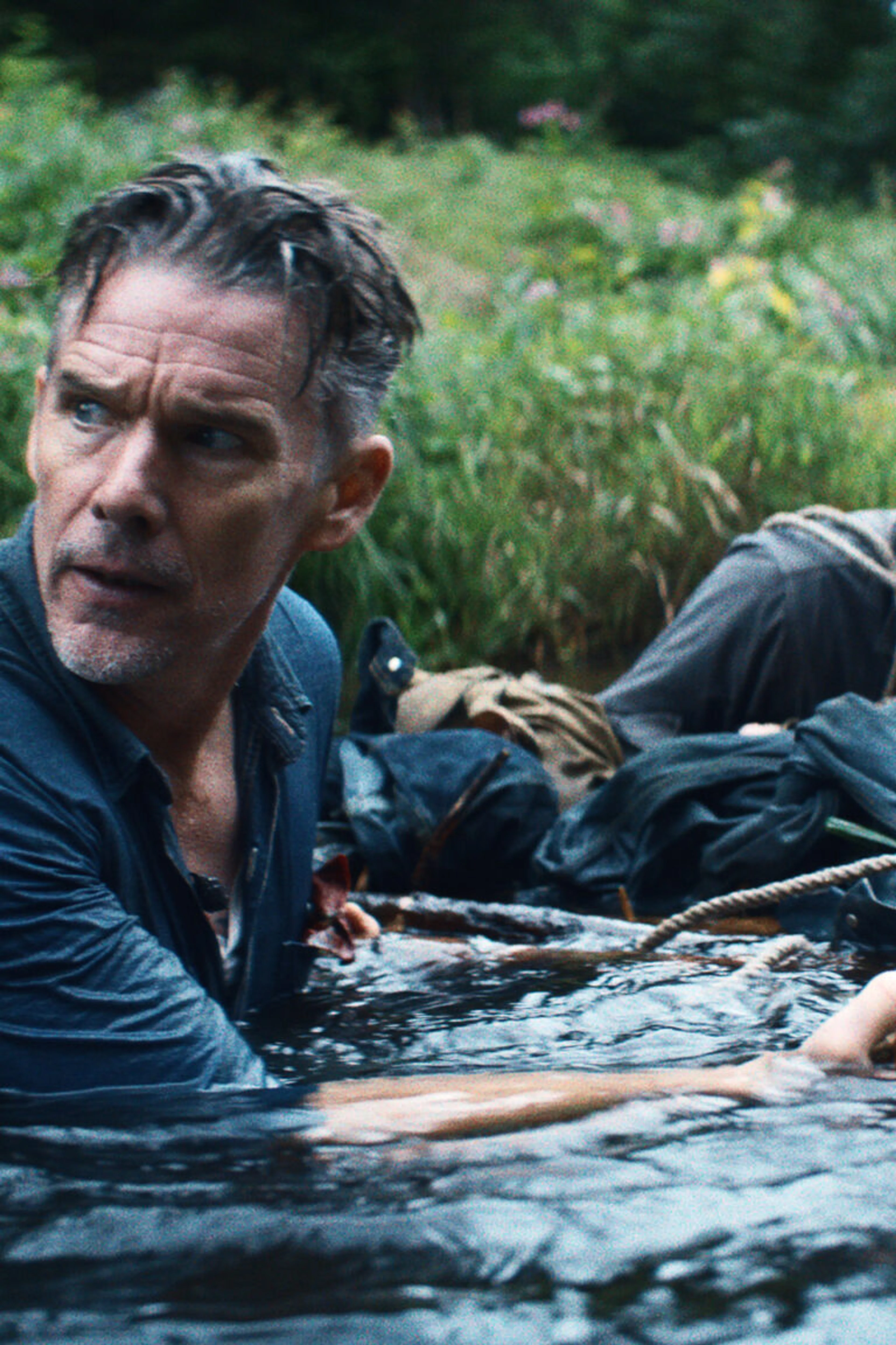 Ethan Hawke looks across a river in a scene from The Weight.
