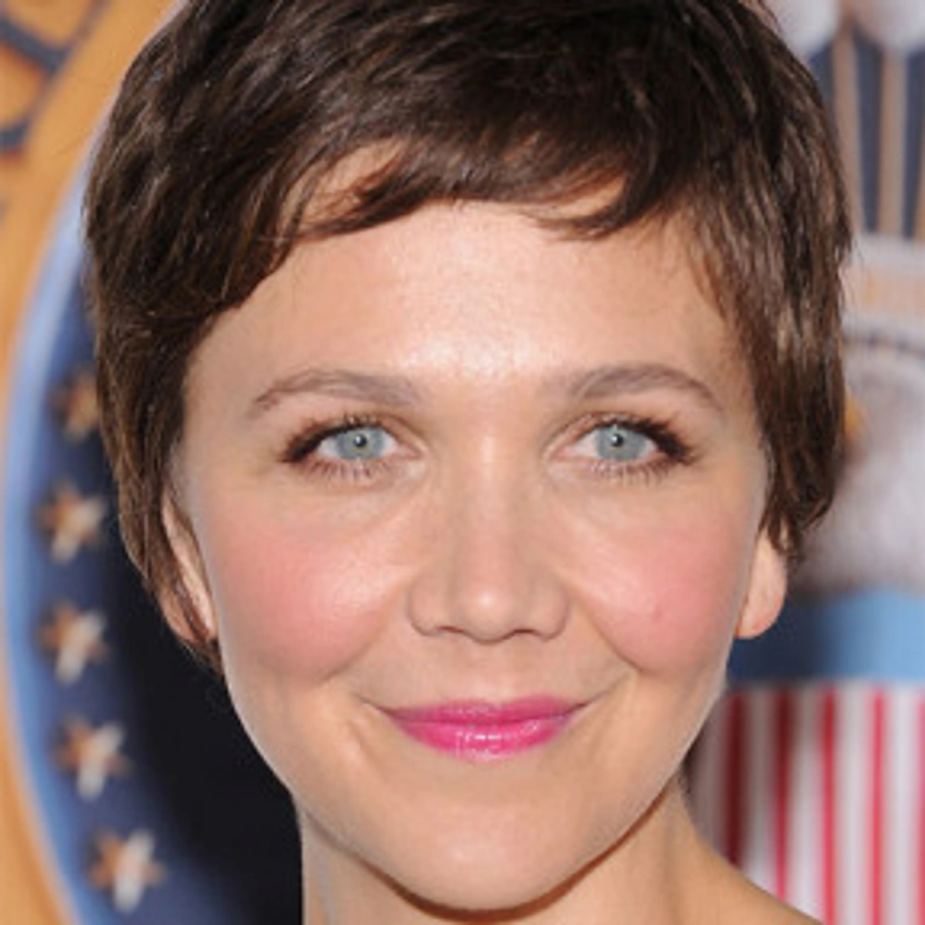 Portrait of Maggie Gyllenhaal with short brown hair.