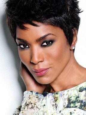 Portrait of Angela Bassett with short dark hair and a patterned top.