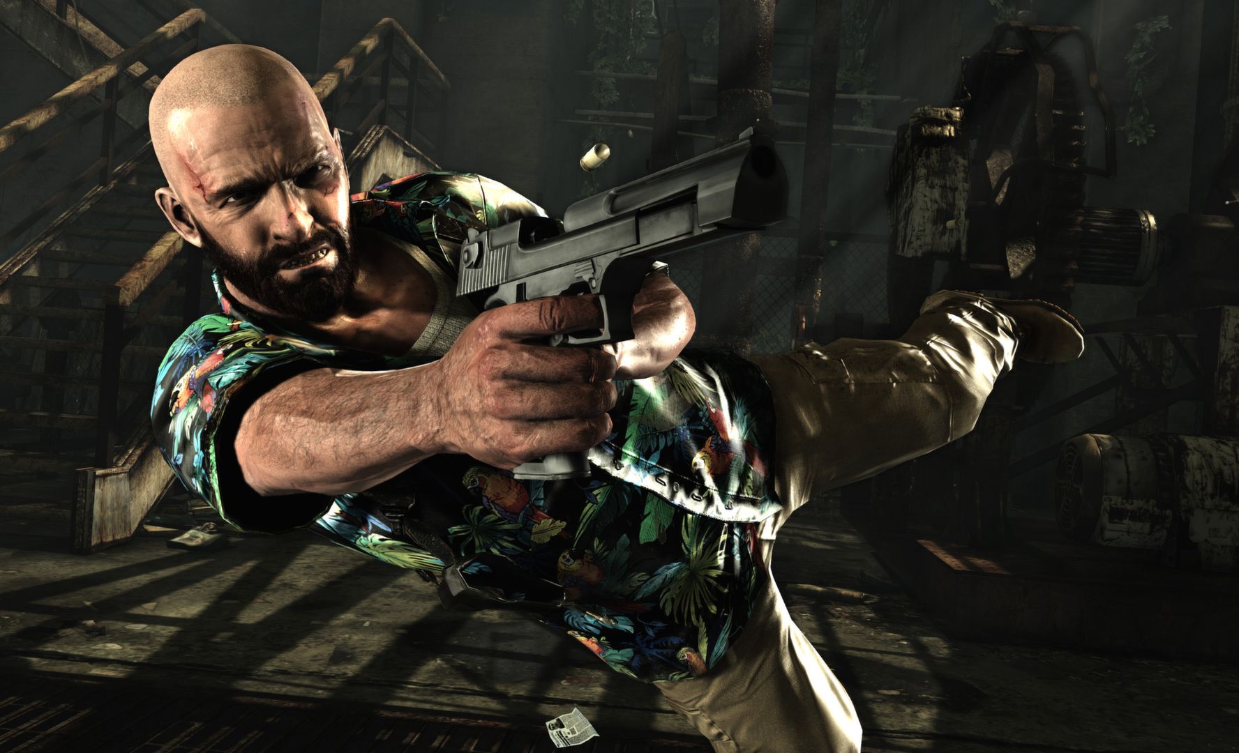 Max fires a pistol during a sideways dive inside an industrial room.
