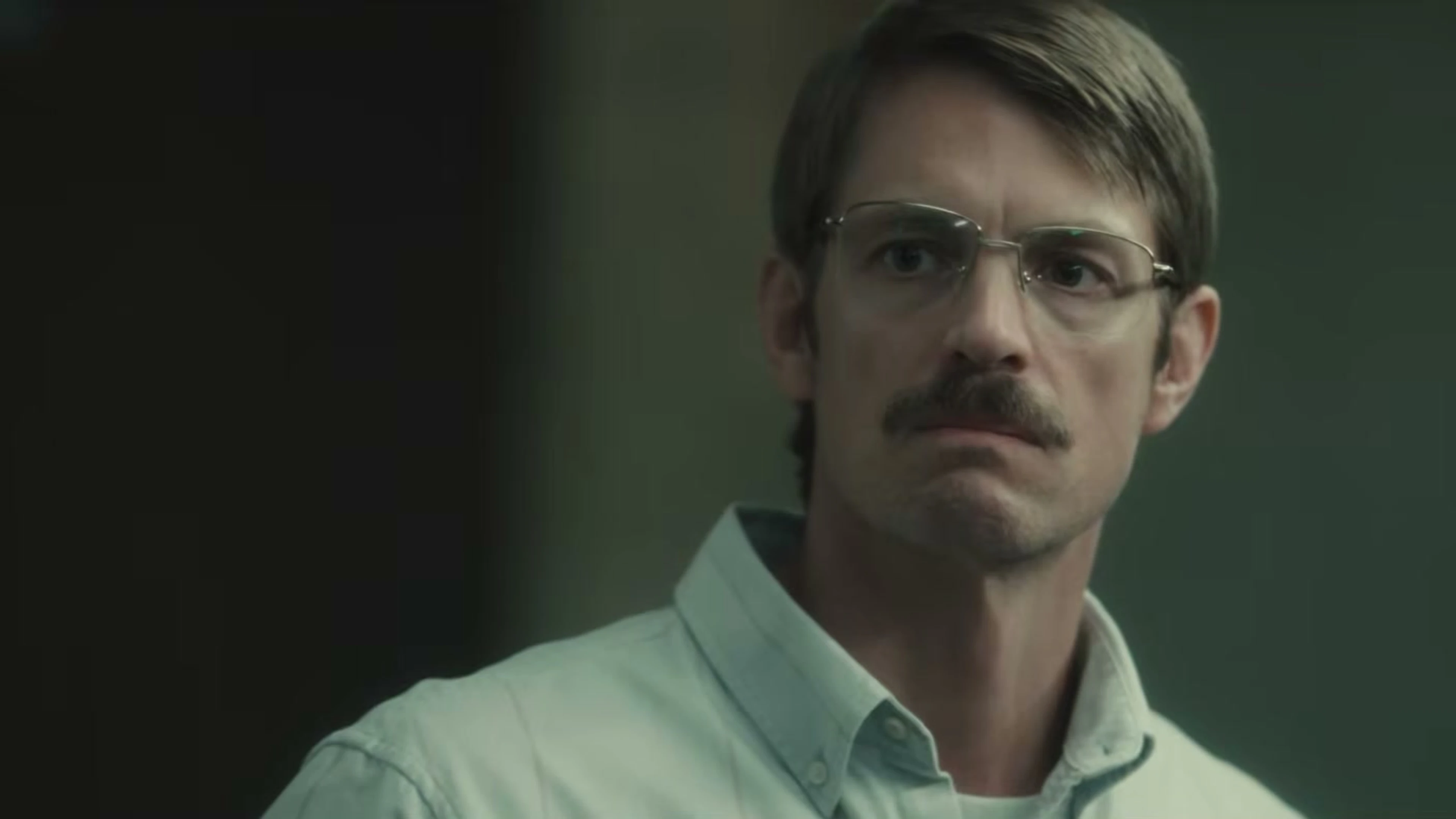 Joel Kinnaman as John Nixon wears glasses in High Value Target: The Hunt for Saddam.