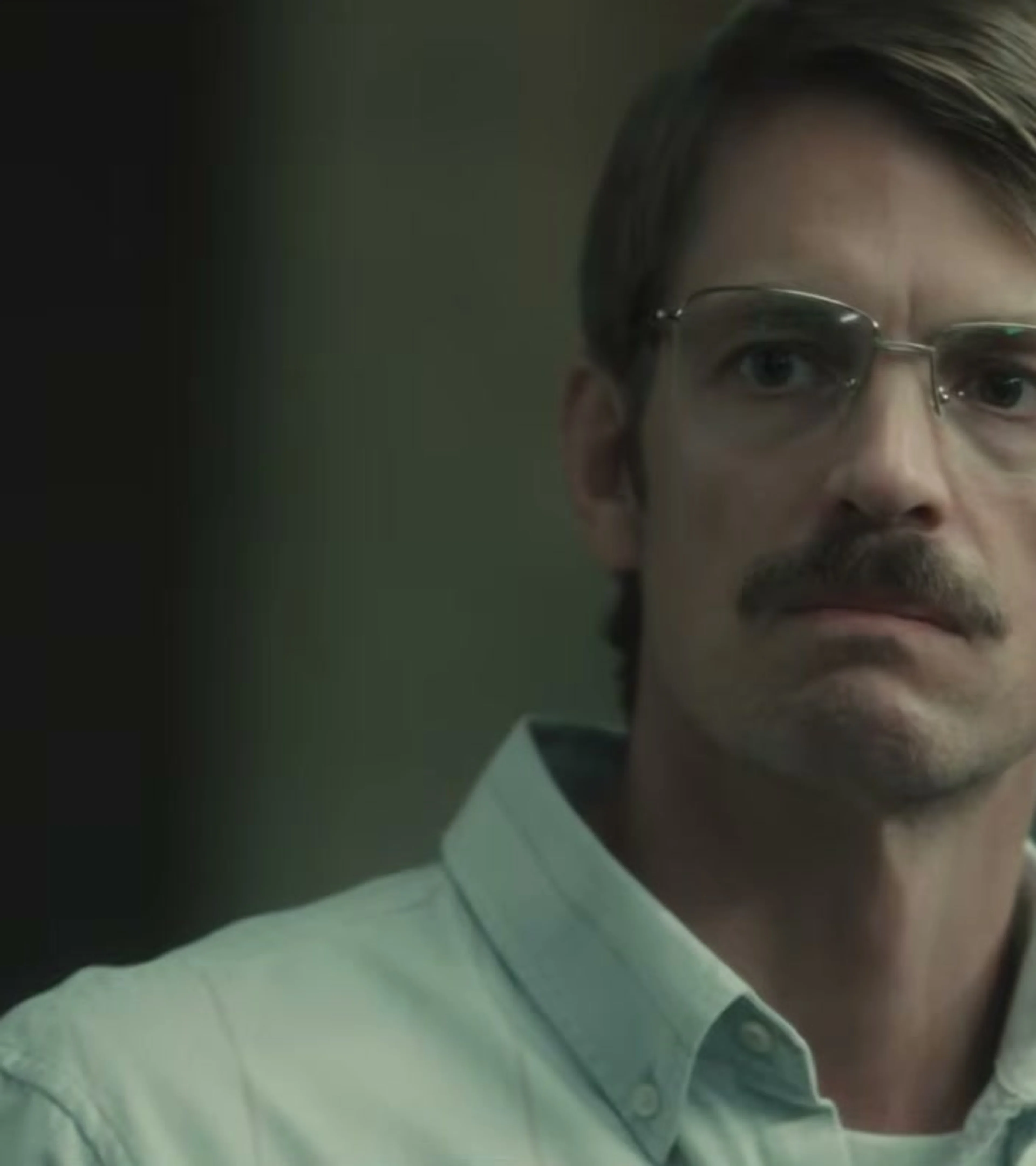 Joel Kinnaman as John Nixon wears glasses in High Value Target: The Hunt for Saddam.