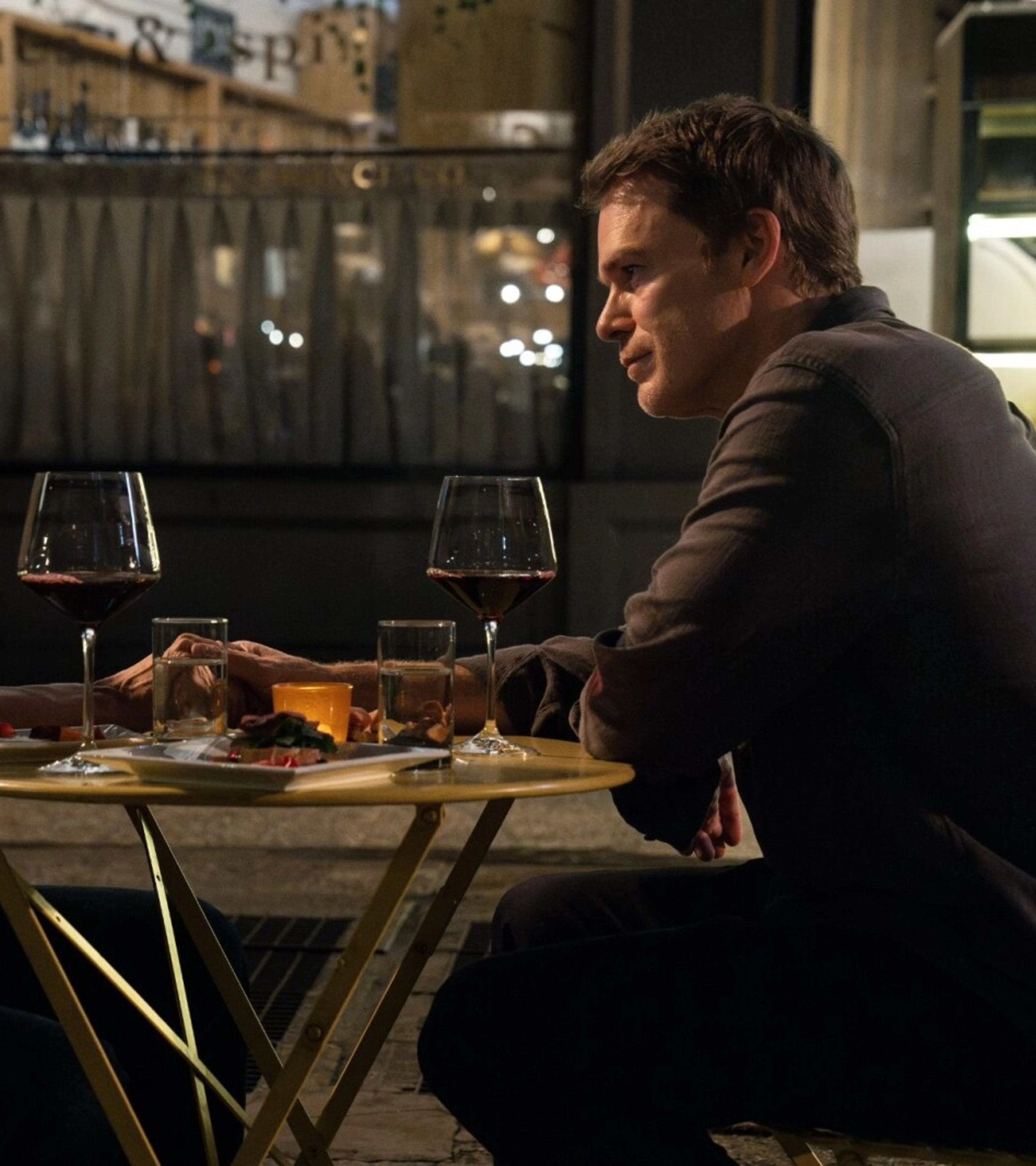 Uma Thurman as Charley sits across a table from Michael C. Hall as Dexter Morgan in a Season 2 first-look still.