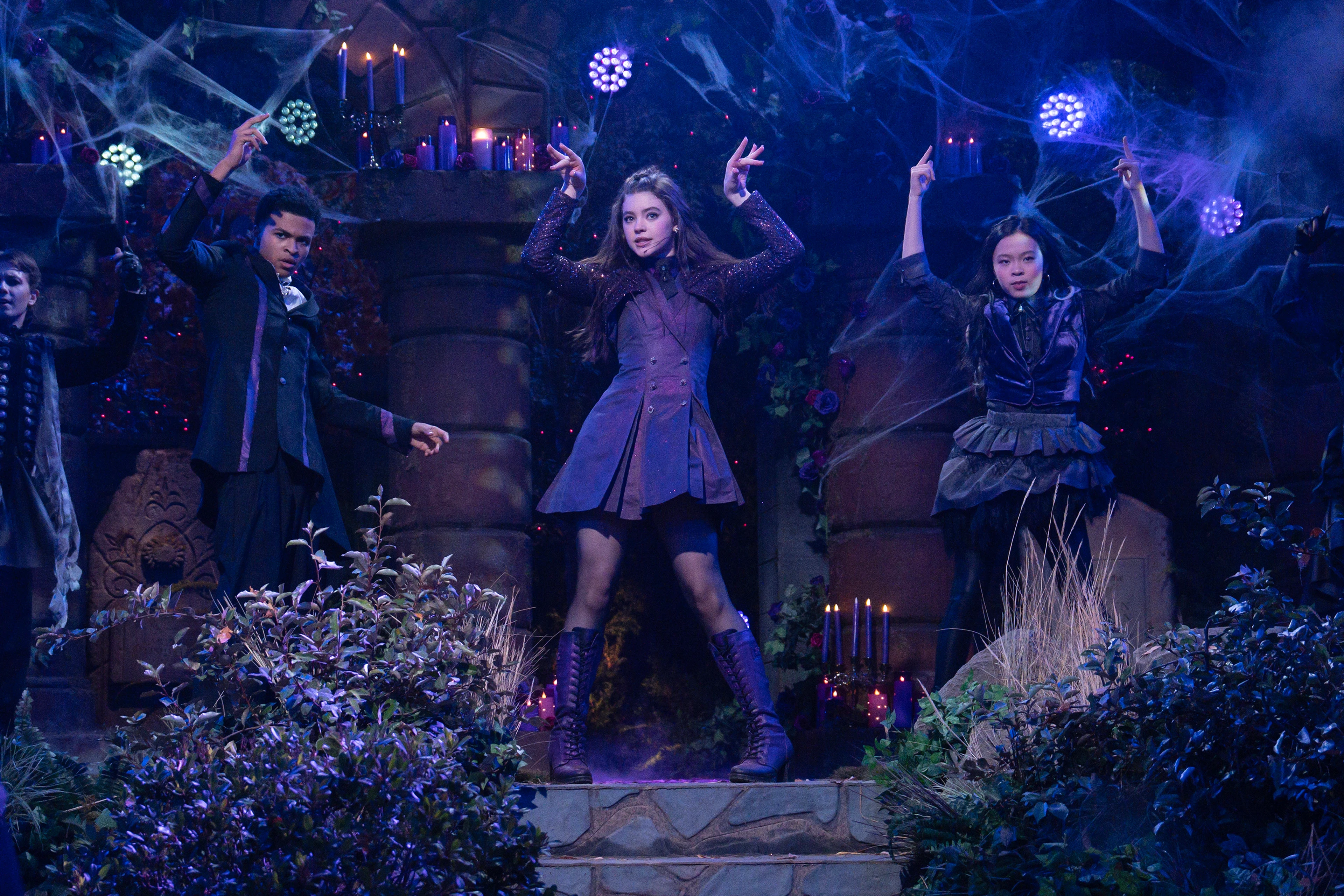 Shaun Dixon as Elijah, Kenzi Richardson as Vee, and Jiwon Lee as Sophie perform on a blue-lit supernatural stage in Vampirina: Teenage Vampire Season 2.