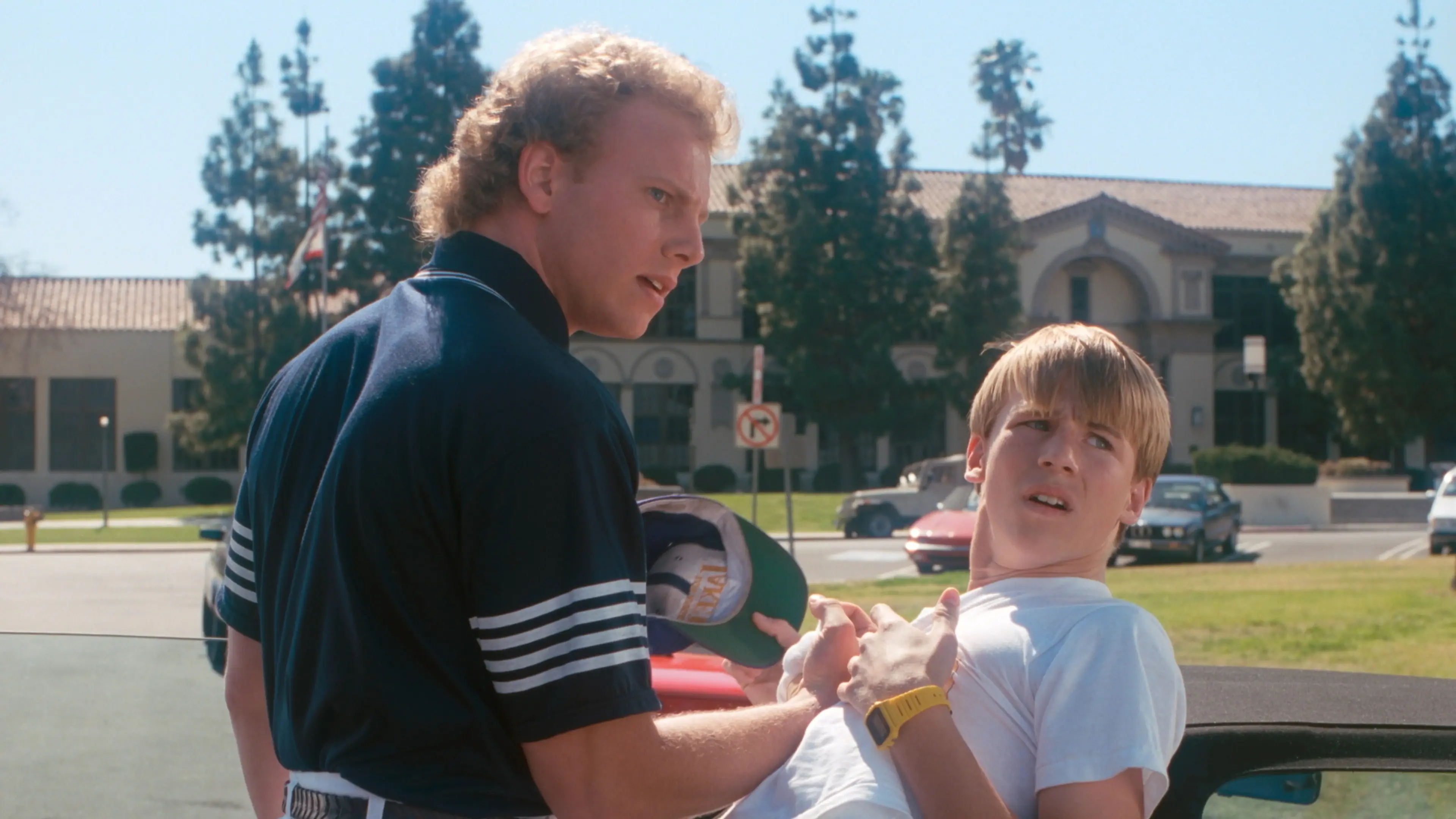 Ian Ziering and Douglas Emerson as Steve Sanders and Scott Scanlon outside West Beverly High.