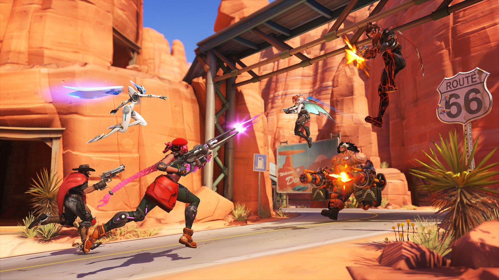 Overwatch heroes battle along Route 66 in a desert canyon.