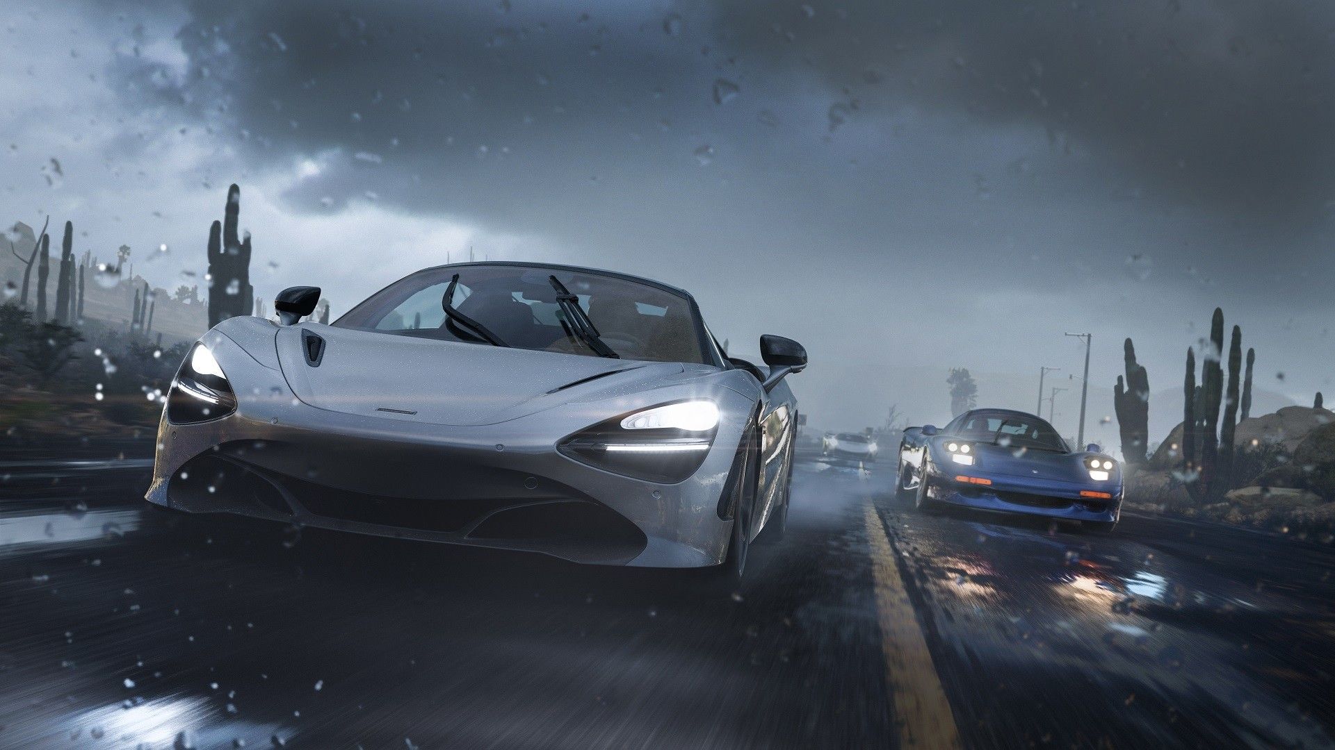 Two sports cars race in rainy weather.