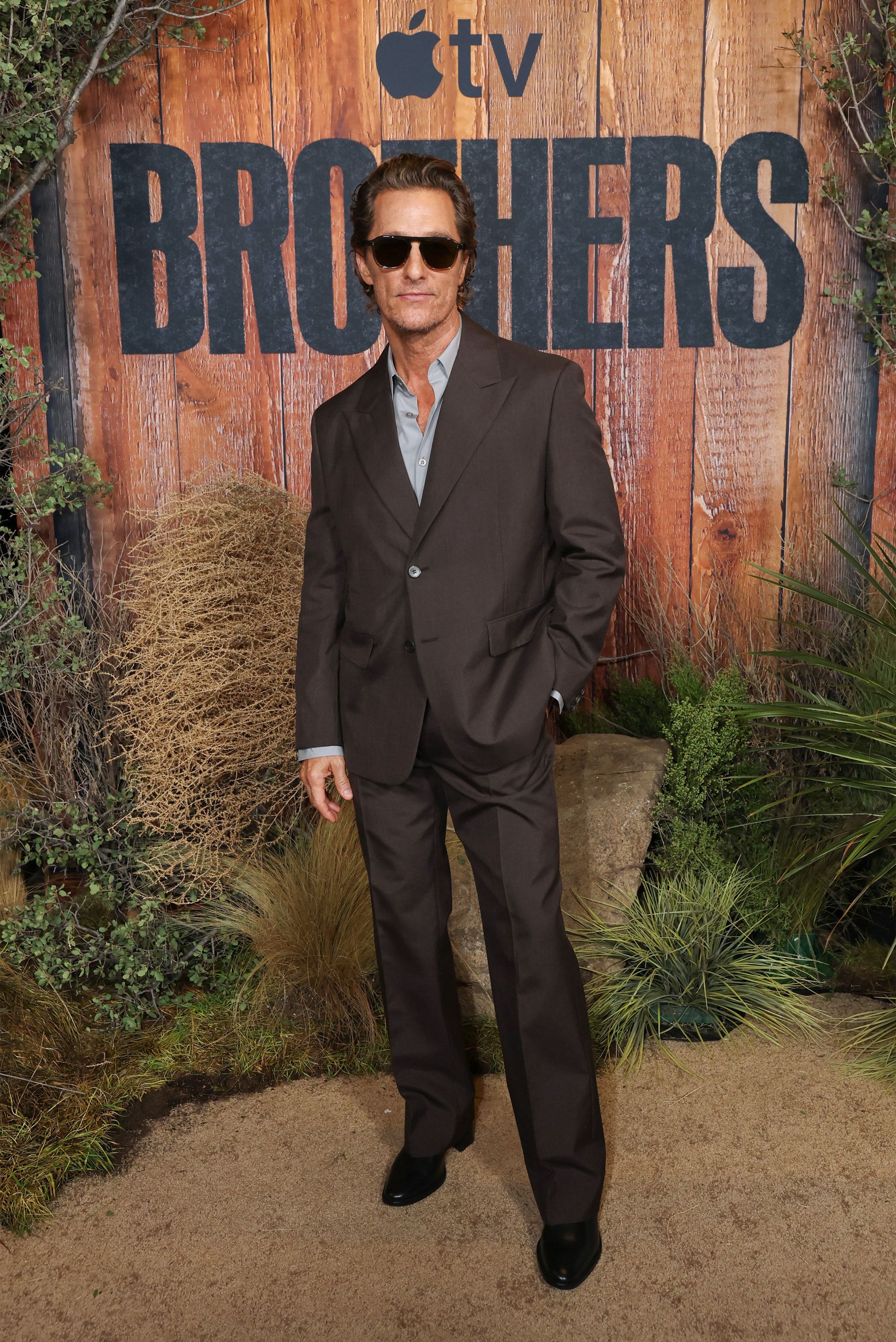 Matthew McConaughey wears a dark suit and sunglasses at the Brothers world premiere.