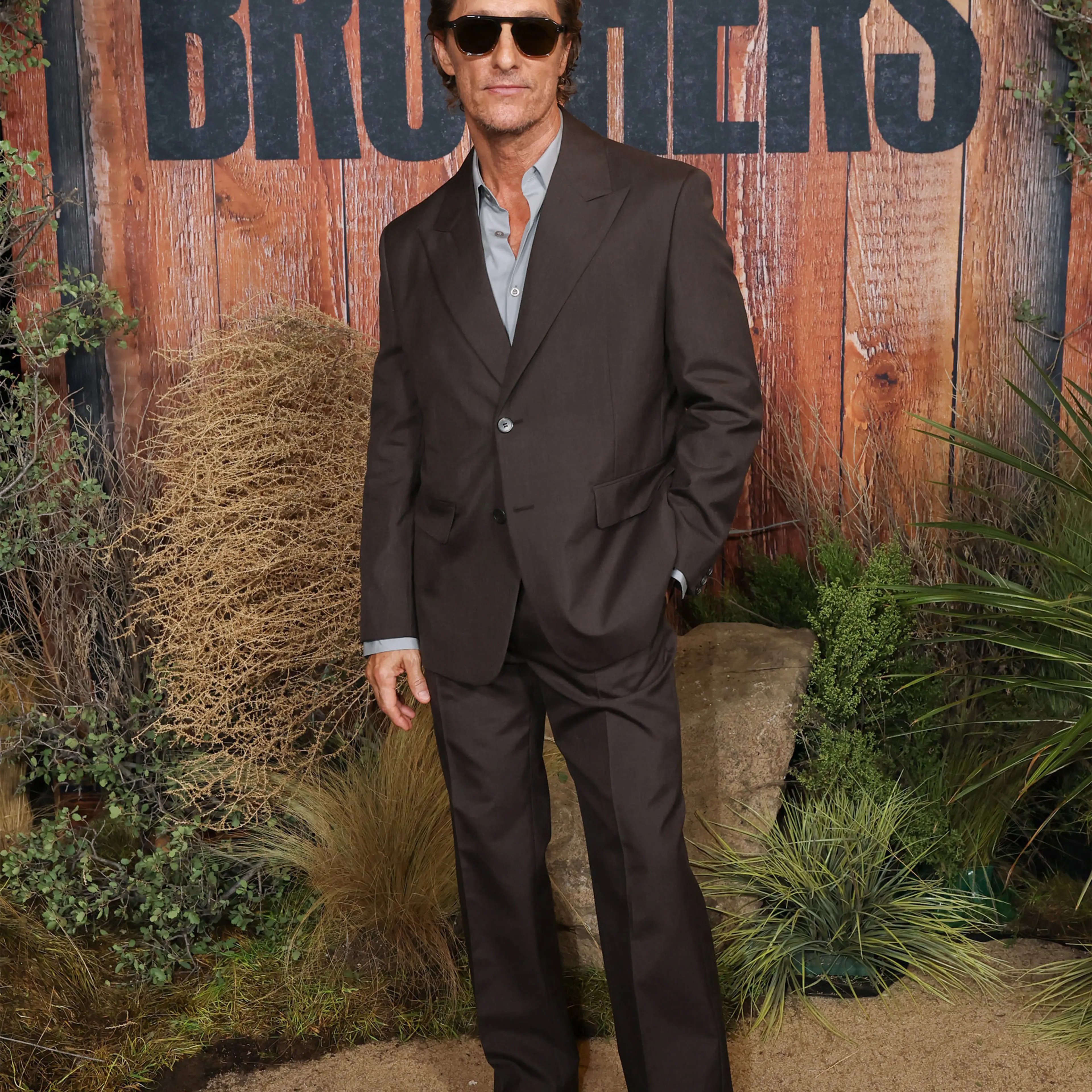 Matthew McConaughey wears a dark suit and sunglasses at the Brothers world premiere.