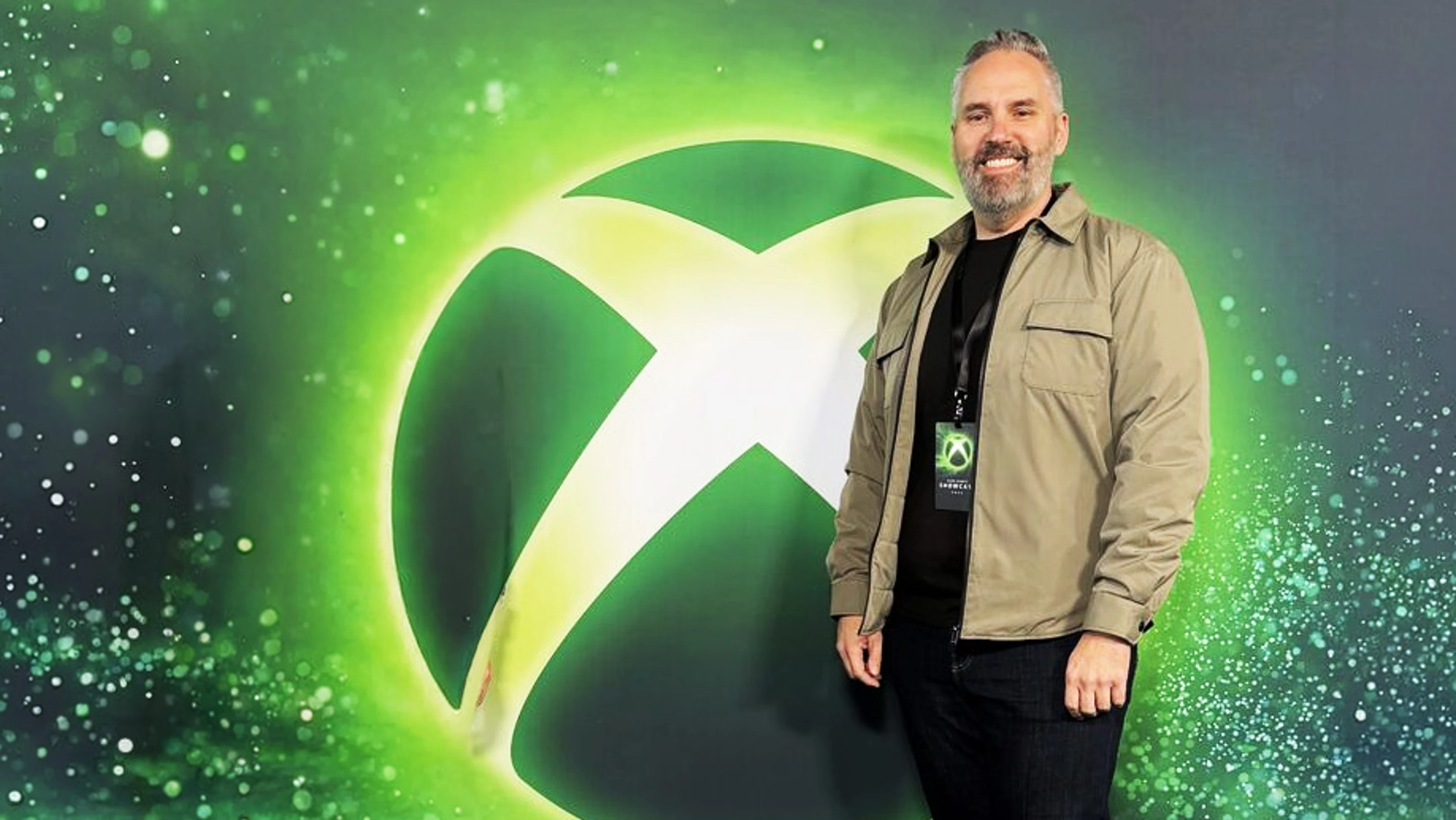 Xbox technology chief Scott Van Vliet stands in front of a large Xbox logo.