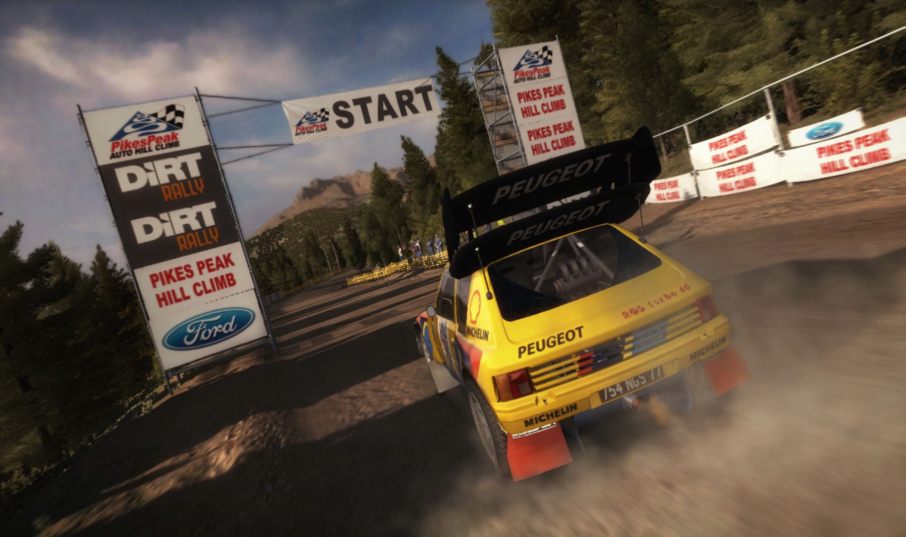 Yellow Peugeot rally car leaves a Pikes Peak start line in a cloud of dust.