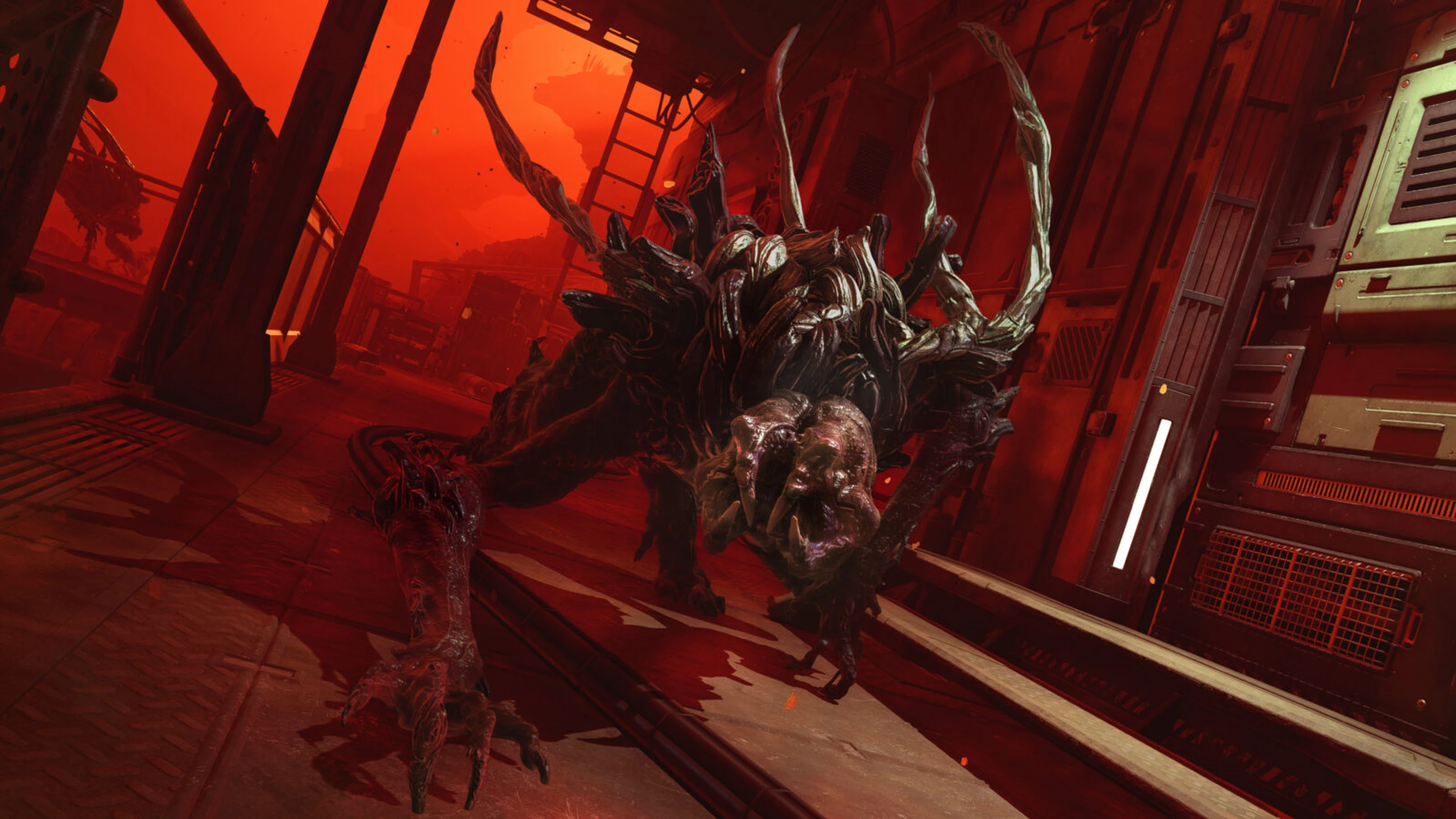 A large alien Soldier advances through a red-lit colony corridor in Alien Deathstorm.