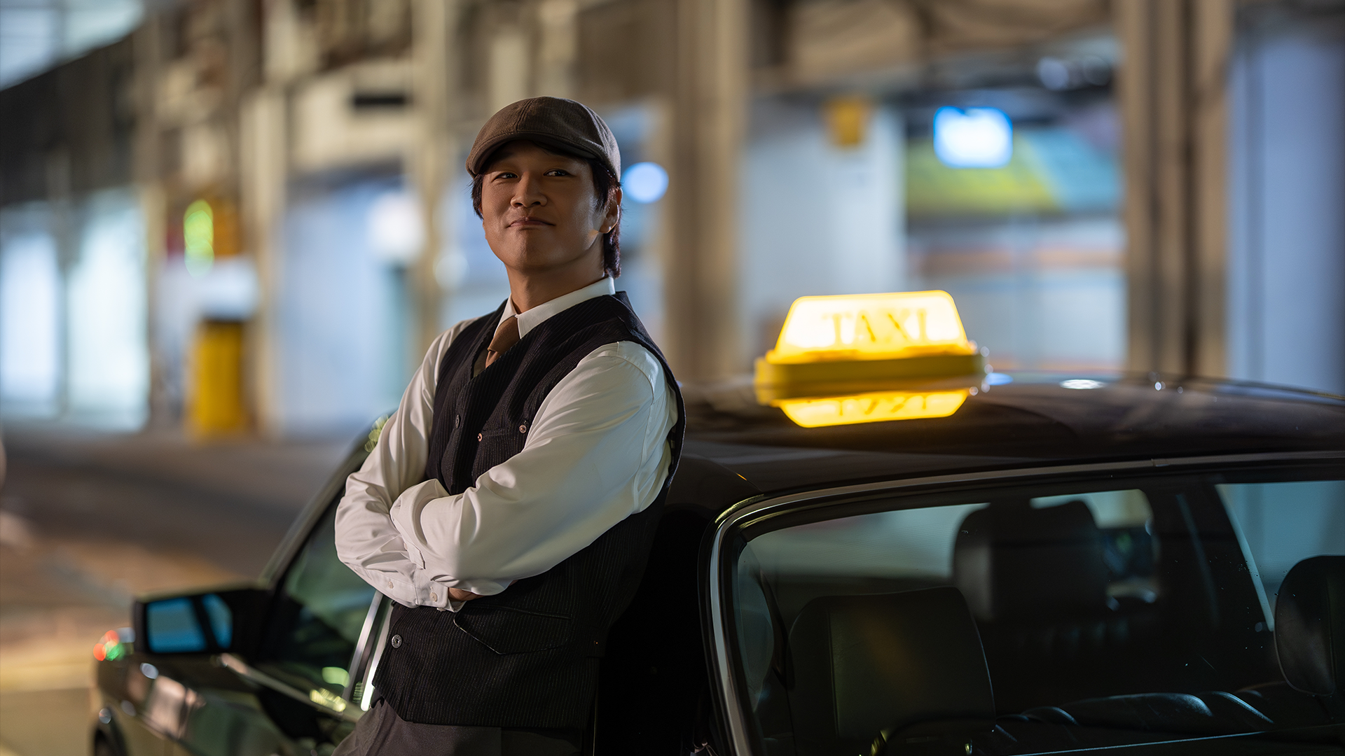 Cha Tae-hyun as Driver Go leans against the classic taxi in Your Personal Taxi.