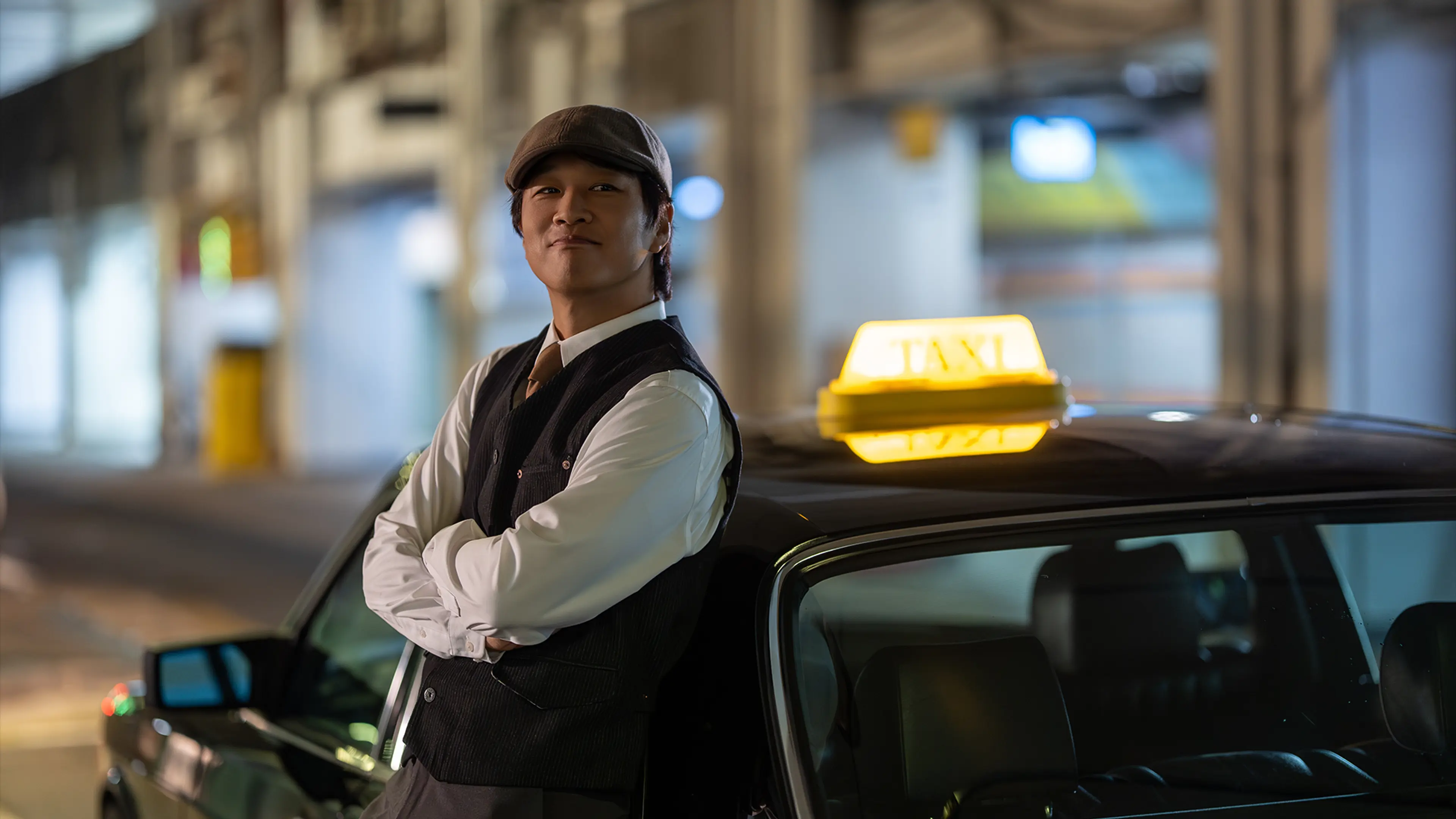 Cha Tae-hyun as Driver Go leans against the classic taxi in Your Personal Taxi.