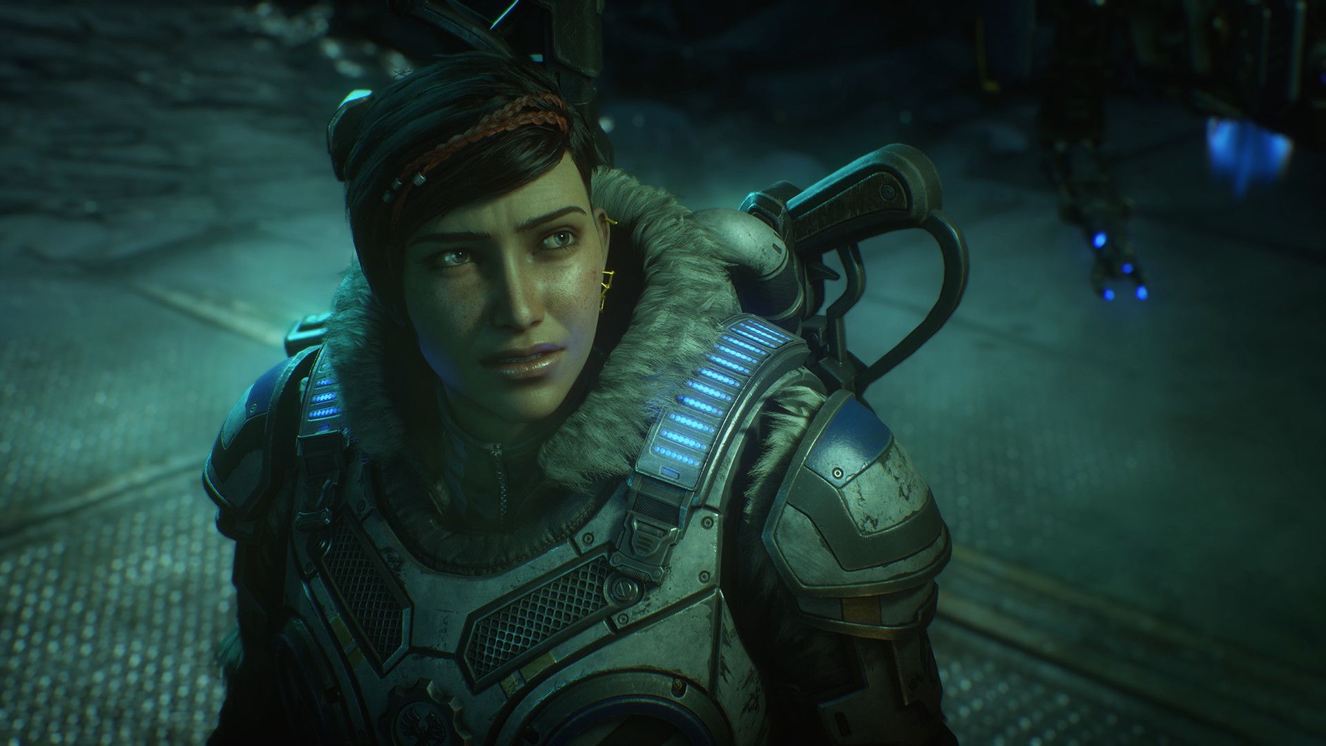 Kait Diaz looks up in a blue-lit story scene while wearing Gears armour.