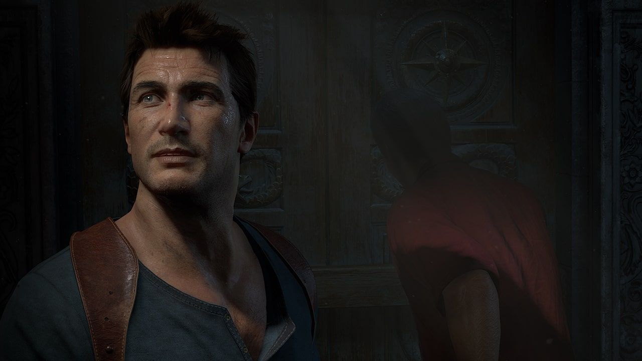 Close-up of Nathan Drake, with another person turned away behind him.