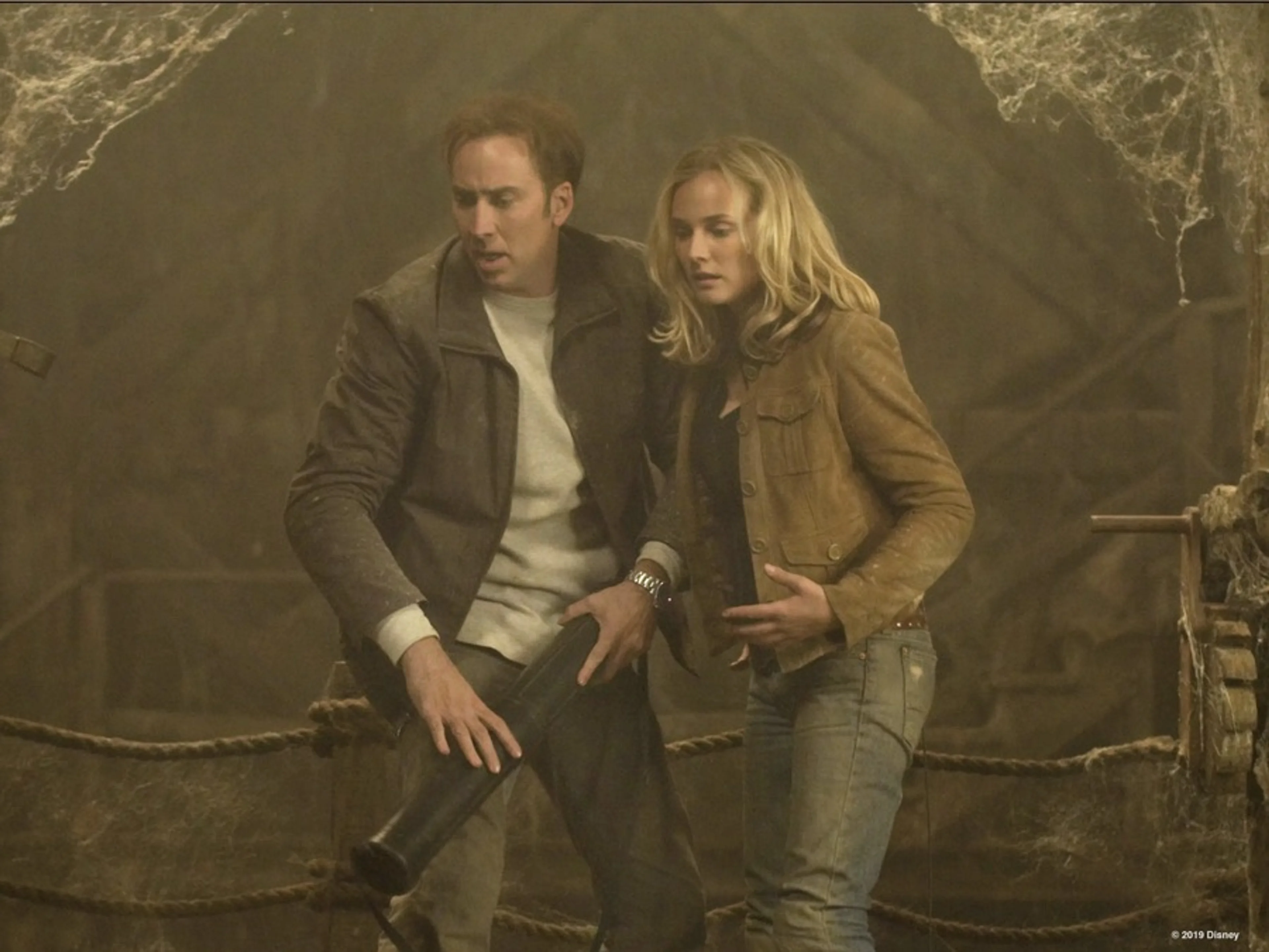 Nicolas Cage and Diane Kruger explore a dusty chamber in National Treasure.