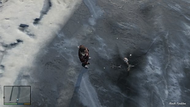 An alien frozen beneath the river ice during GTA 5's Prologue.