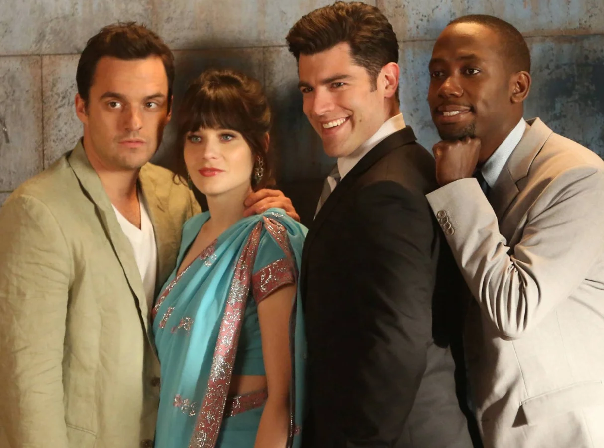 Zooey Deschanel, Jake Johnson, Max Greenfield, and Lamorne Morris pose for a New Girl promotional photograph.