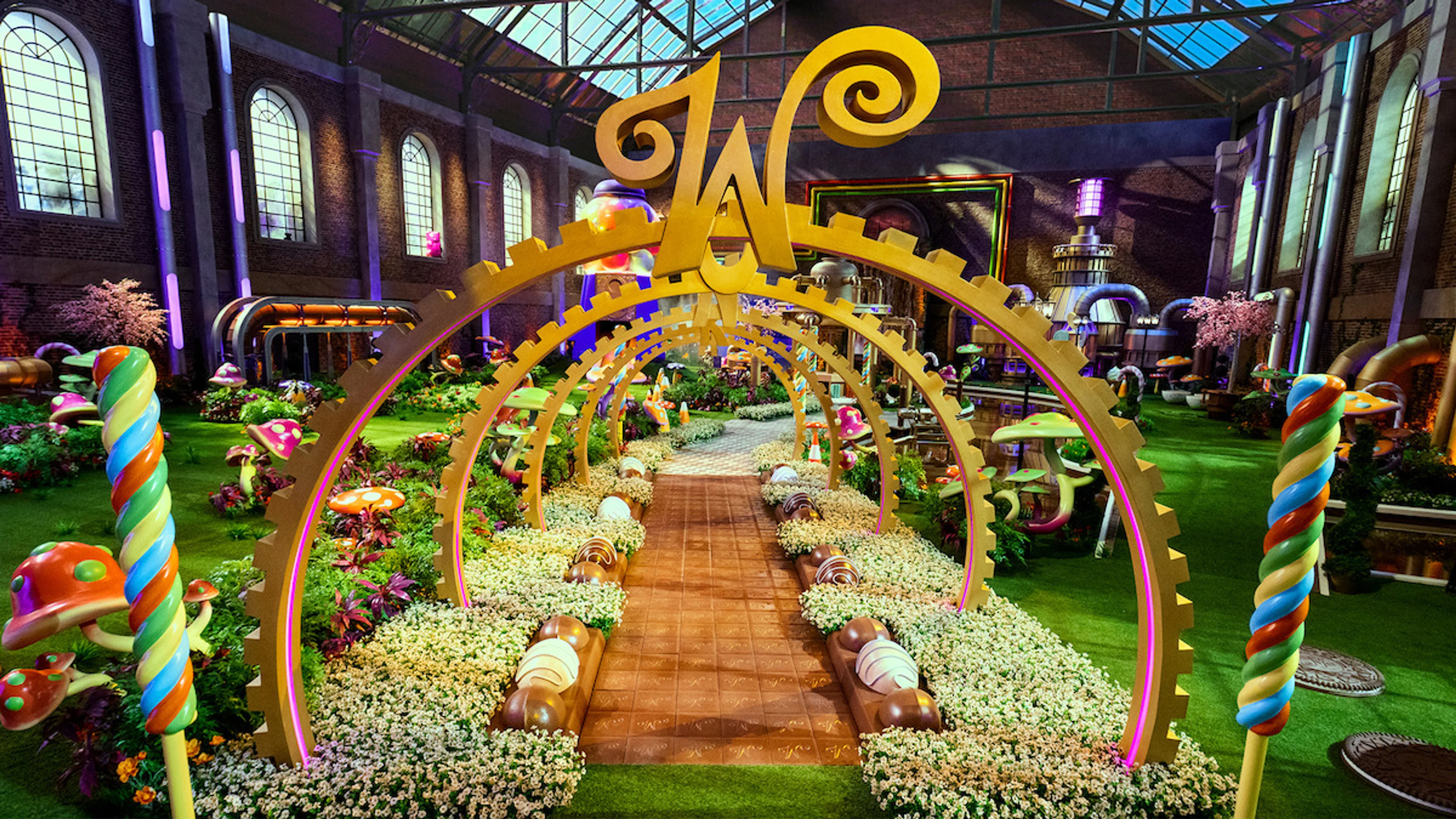 A candy-filled walkway leads into the recreated Chocolate Factory for Wonka’s The Golden Ticket.
