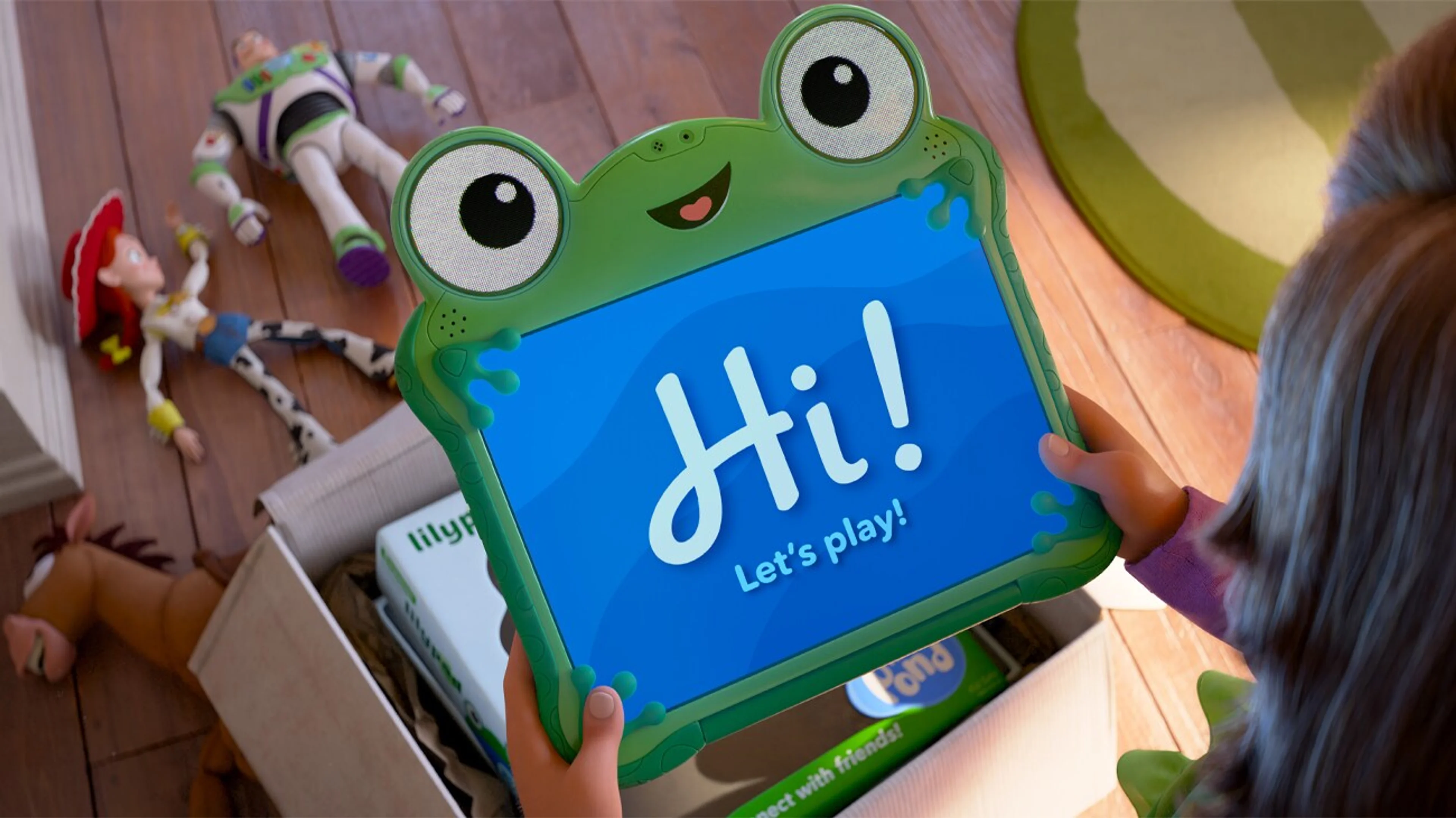 Bonnie holds a green Lilypad tablet above her toys and its opened packaging.