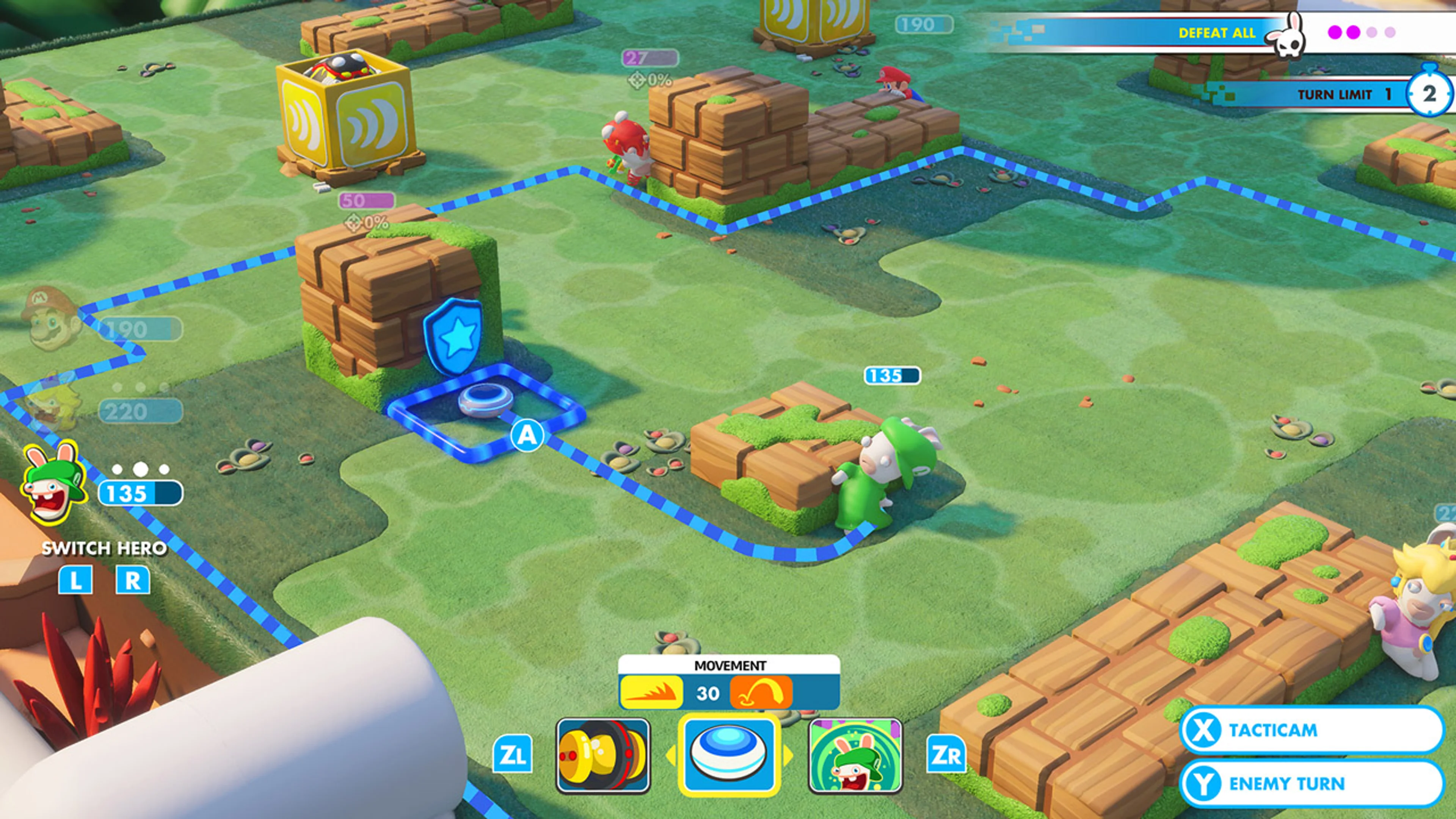 Battle screenshot showing Defeat All at upper right, hero HP at left, blue movement boundary and Tacticam and Enemy Turn prompts at lower right.