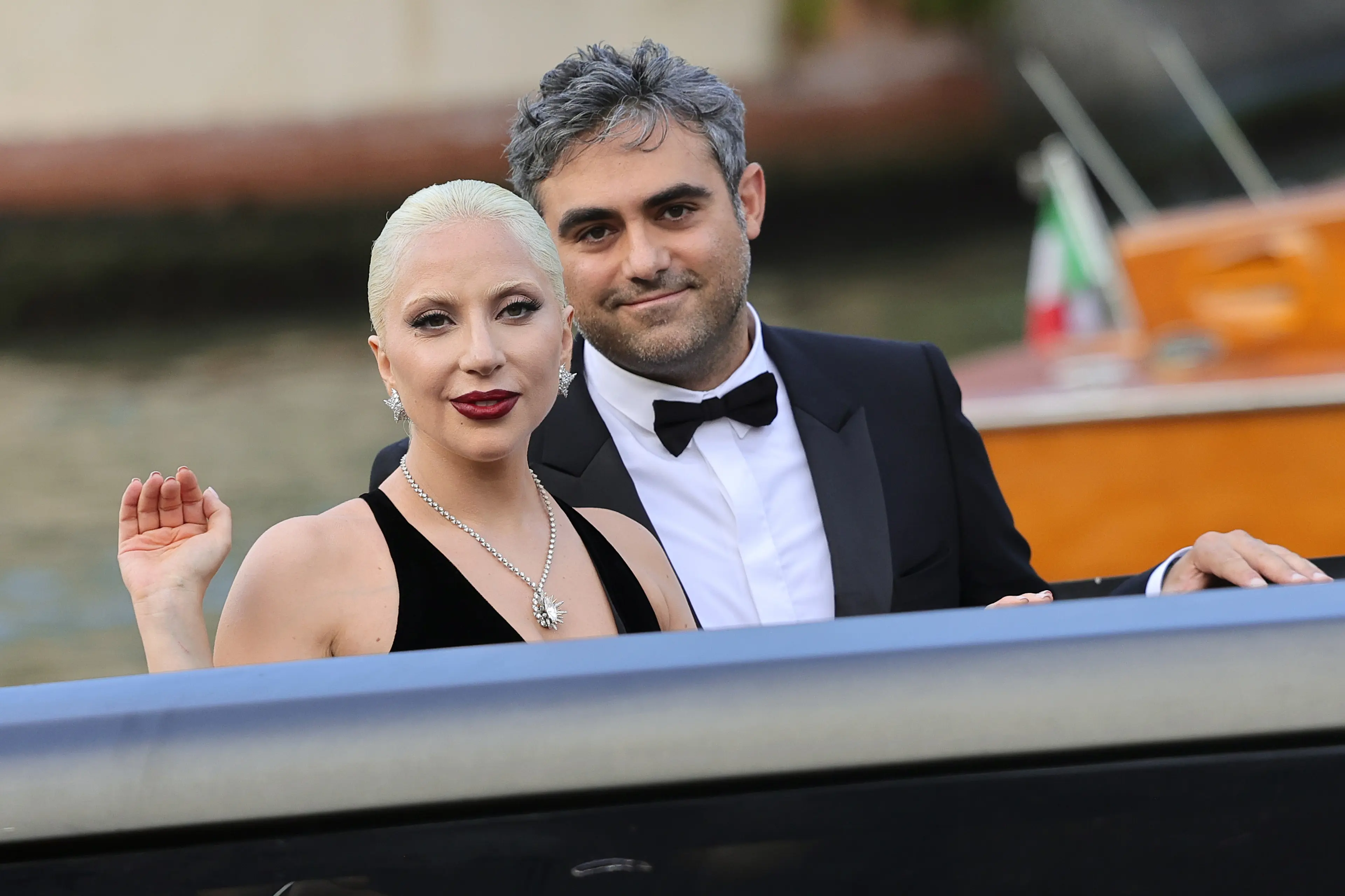 Lady Gaga and Michael Polansky sit together in a boat at the 2024 Venice Film Festival.