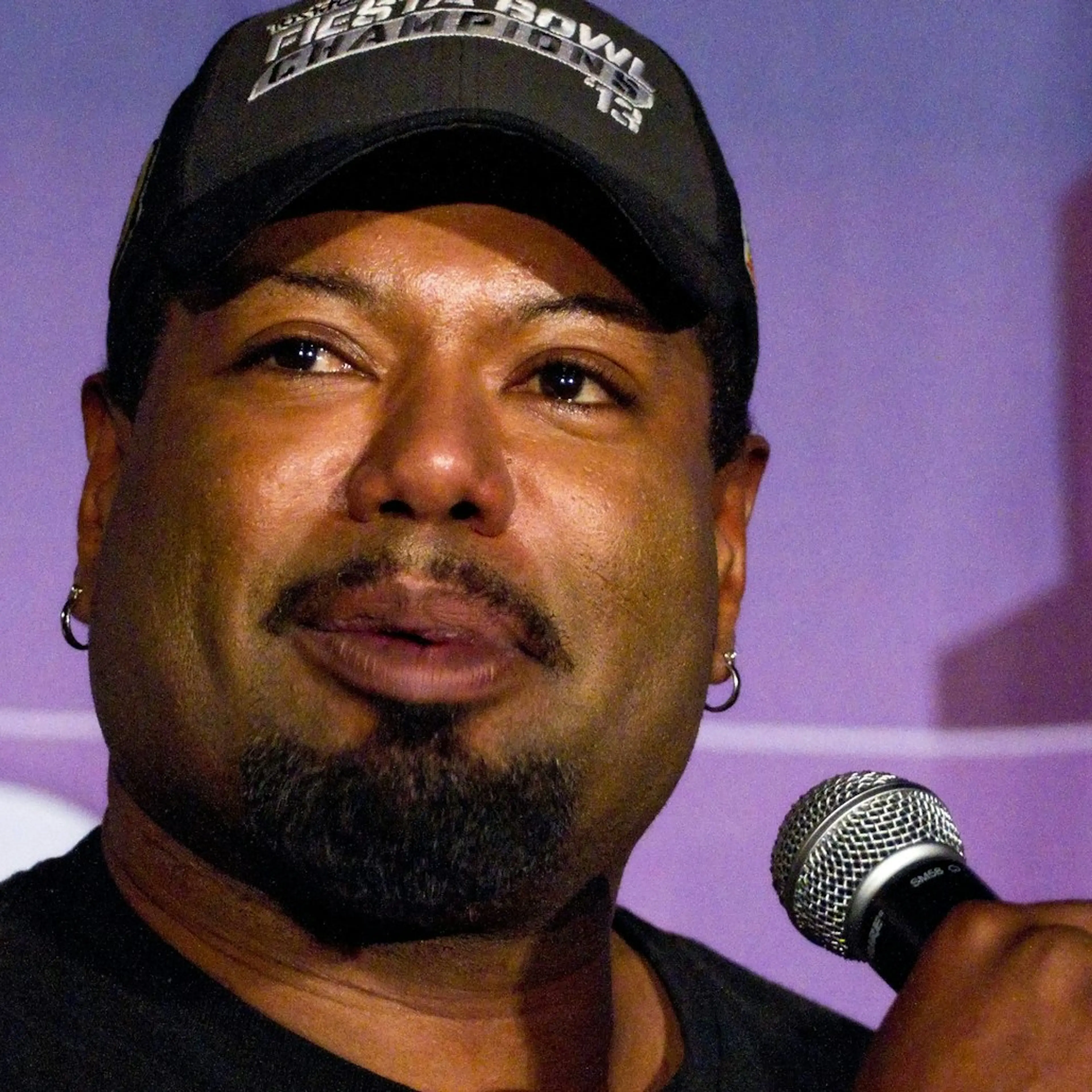 Christopher Judge speaking into a microphone at a FAN EXPO panel.