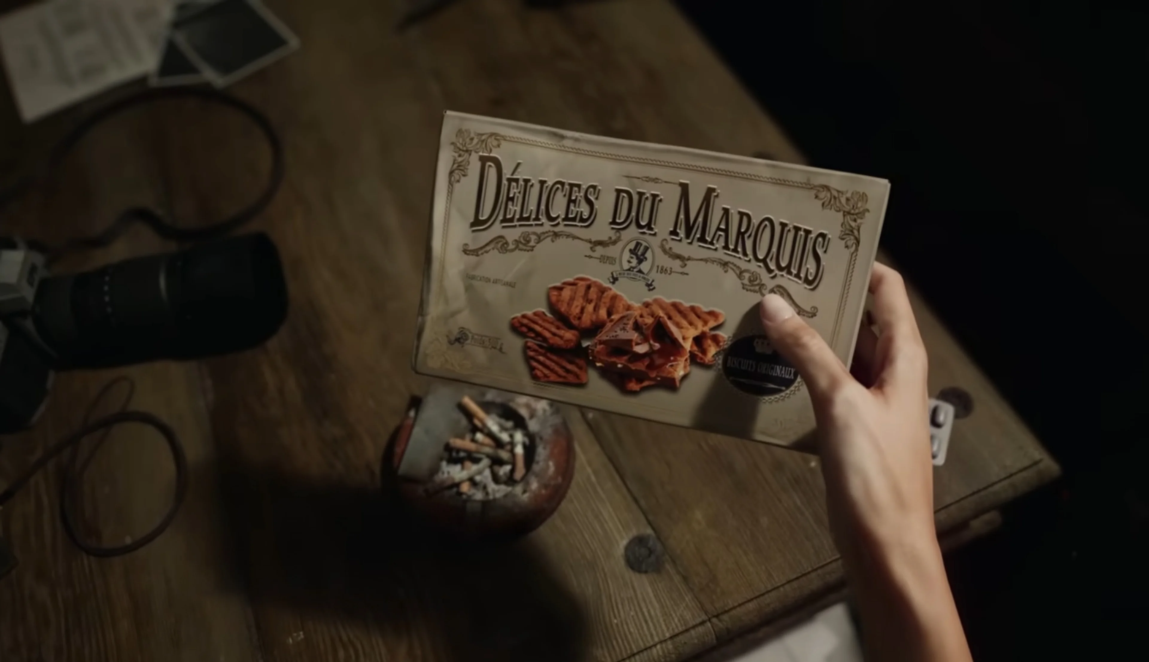 A first-person view shows someone holding a box of biscuits in the Resident Evil Veronica reveal trailer.